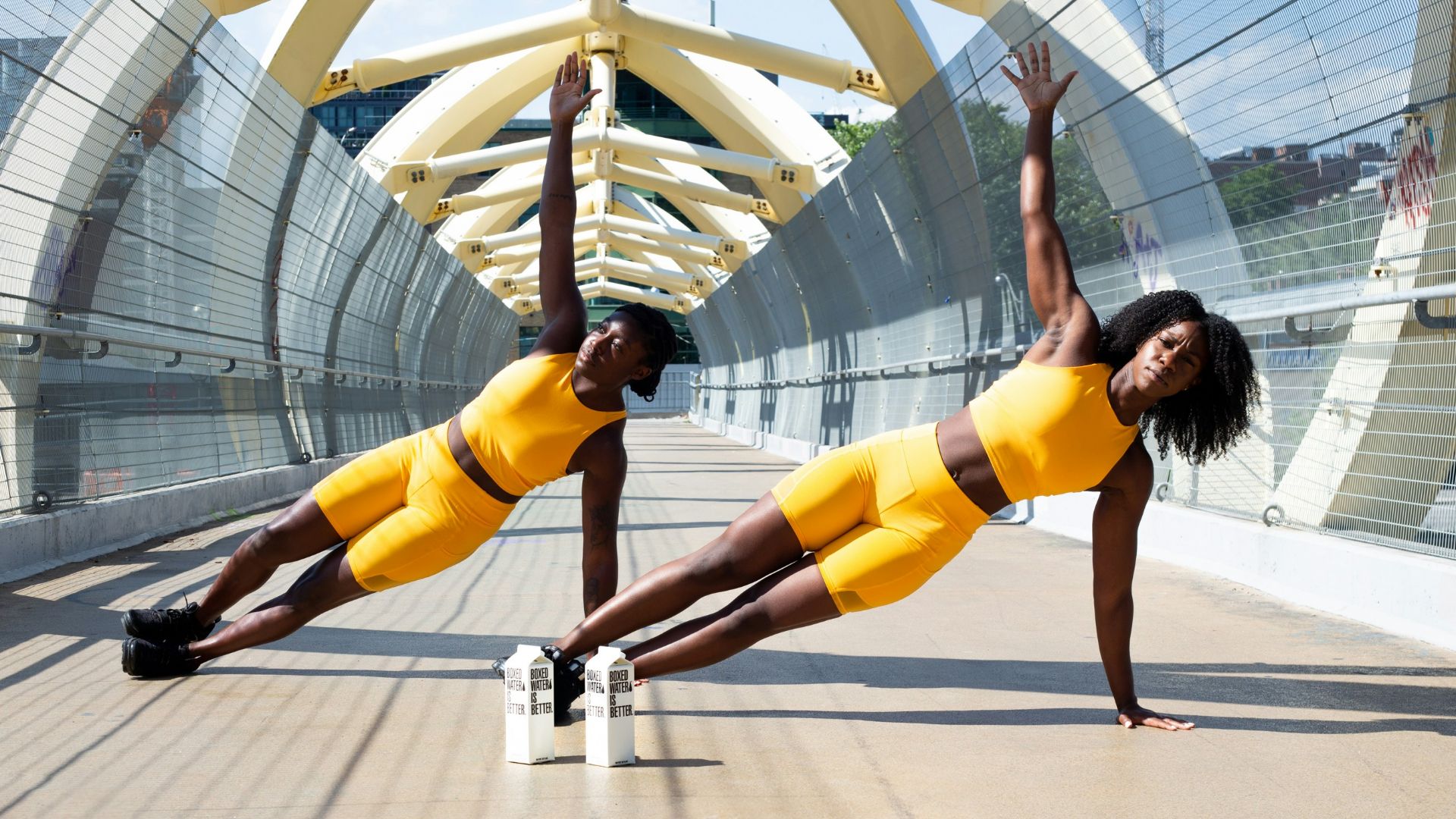 woman in yellow sports bra and yellow shorts jumping on white metal frame