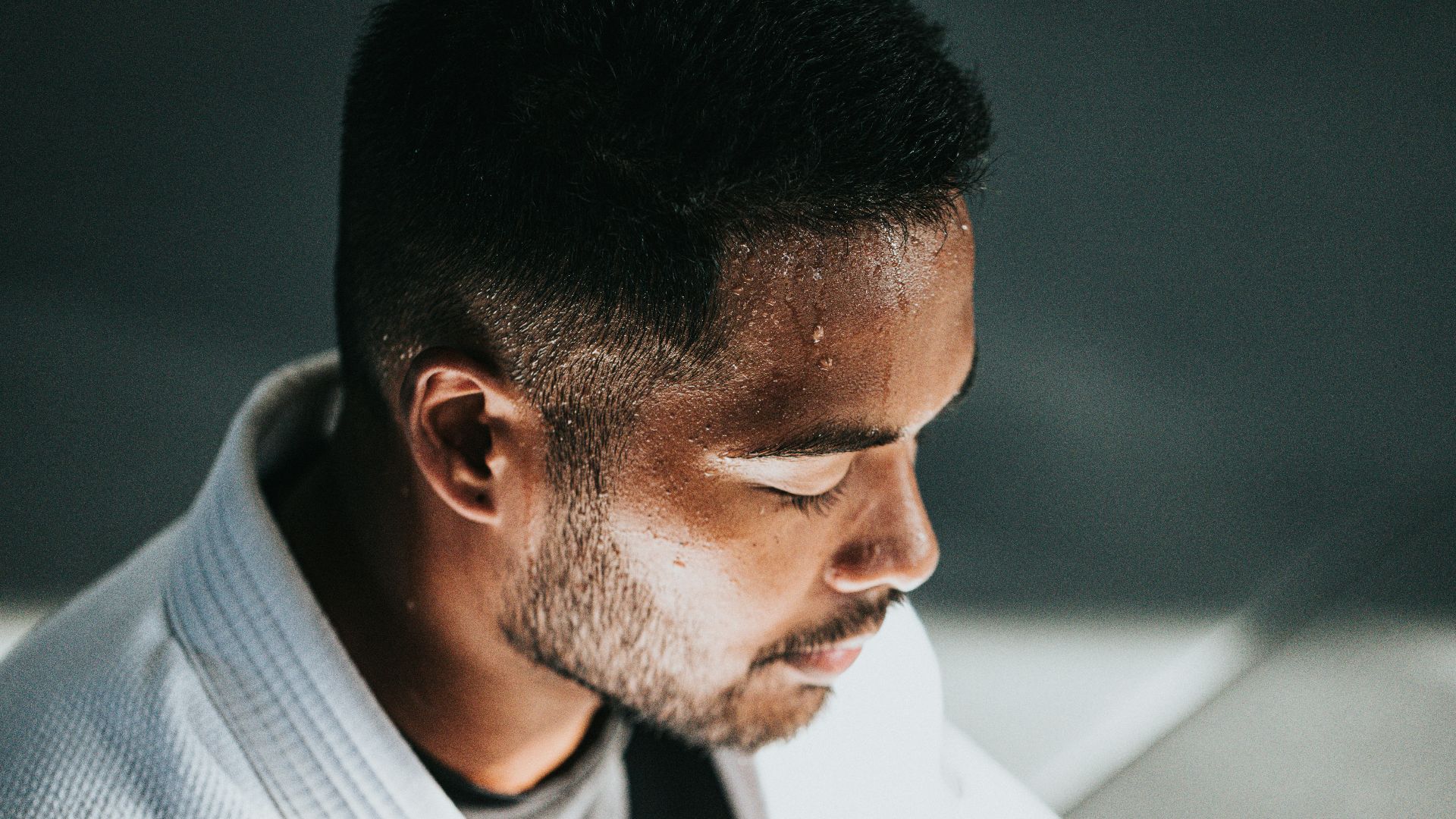 man in white shirt sitting on black chair
