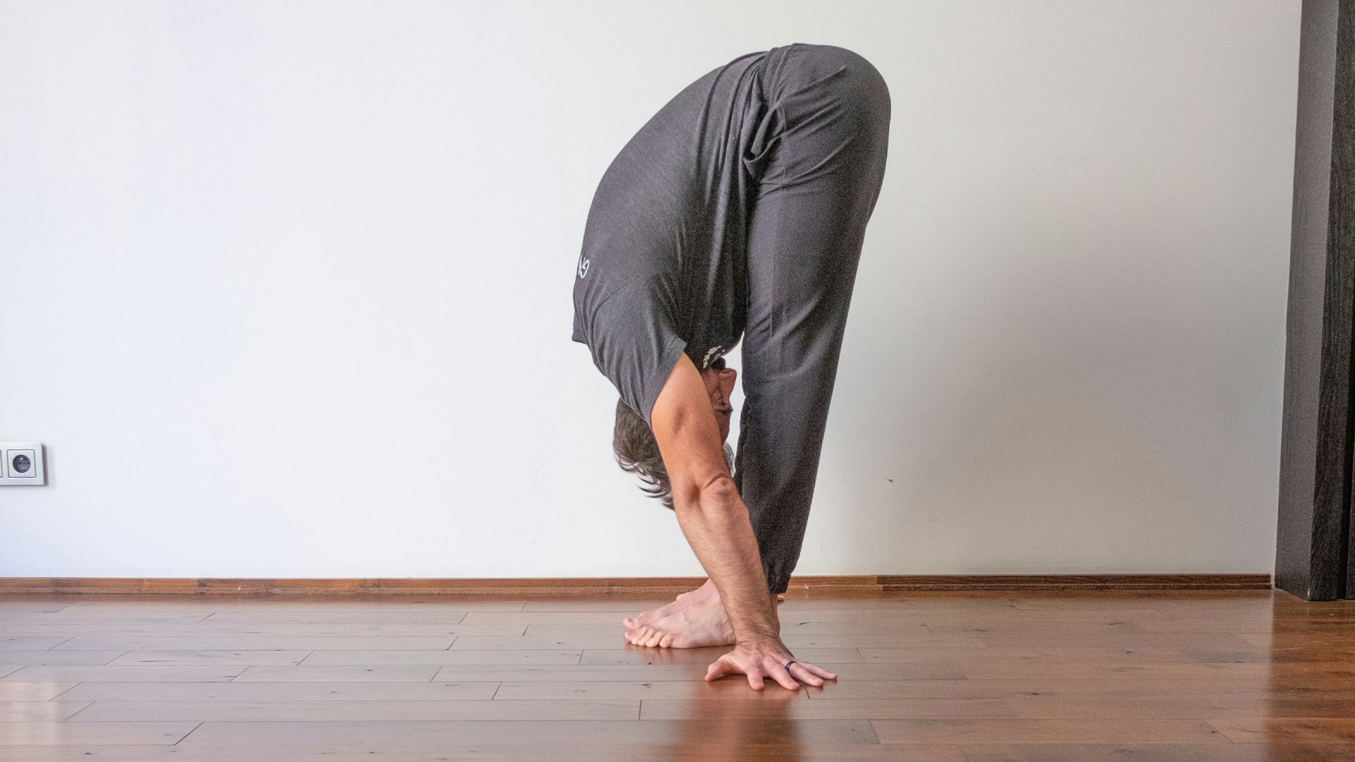 a man doing a handstand on a hard wood floor