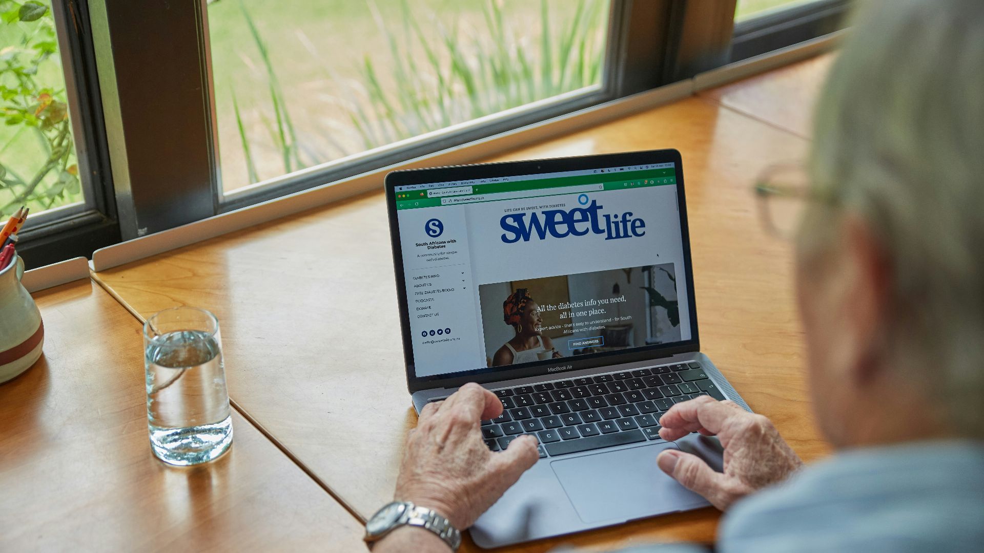 a man sitting at a table using a laptop computer