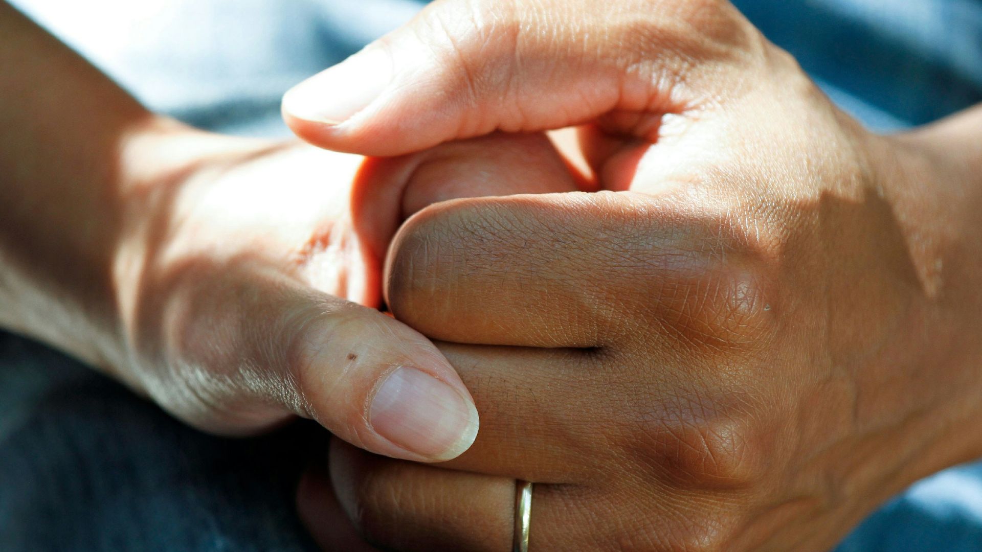 person wearing gold wedding band