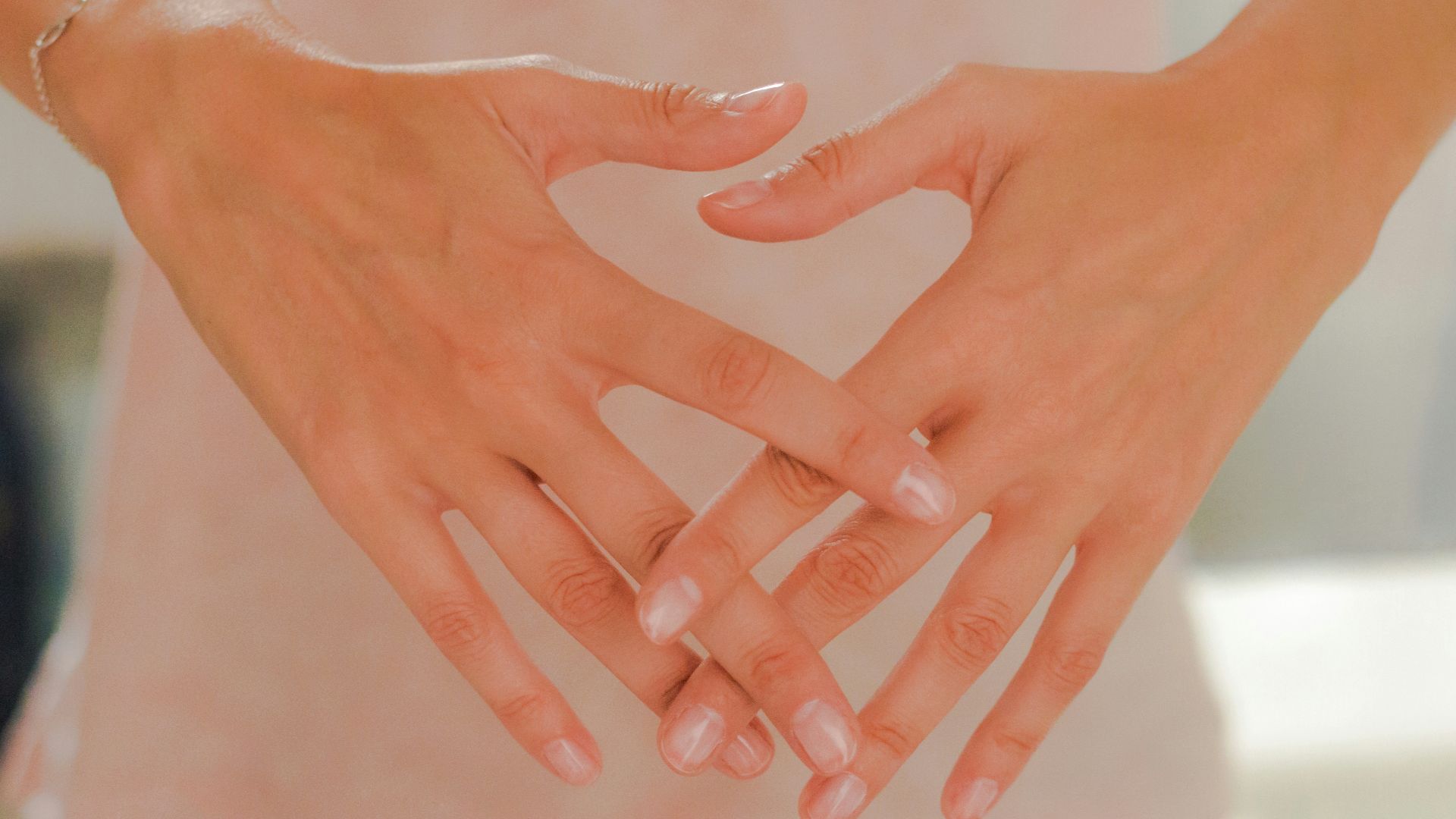 persons hand on white textile