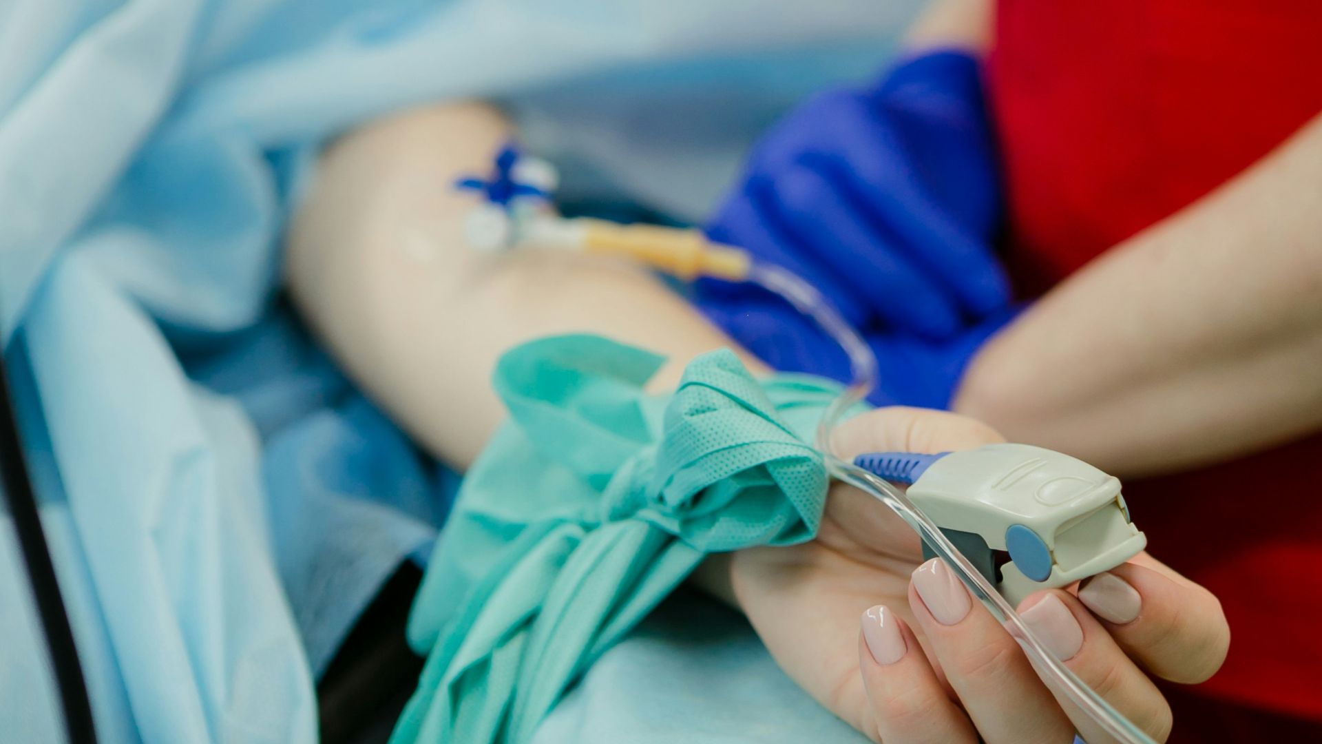 person lying on bed and another person standing