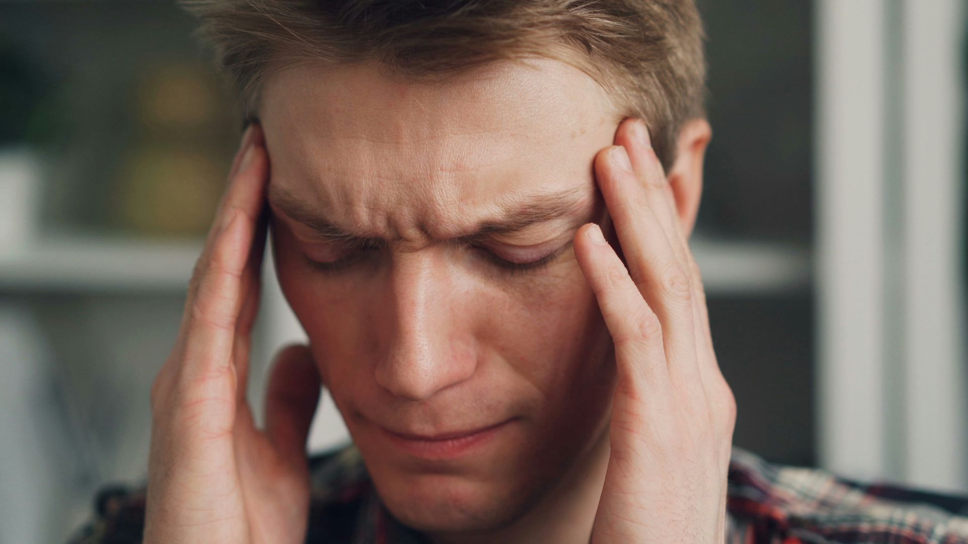 a man holding his hands to his ears
