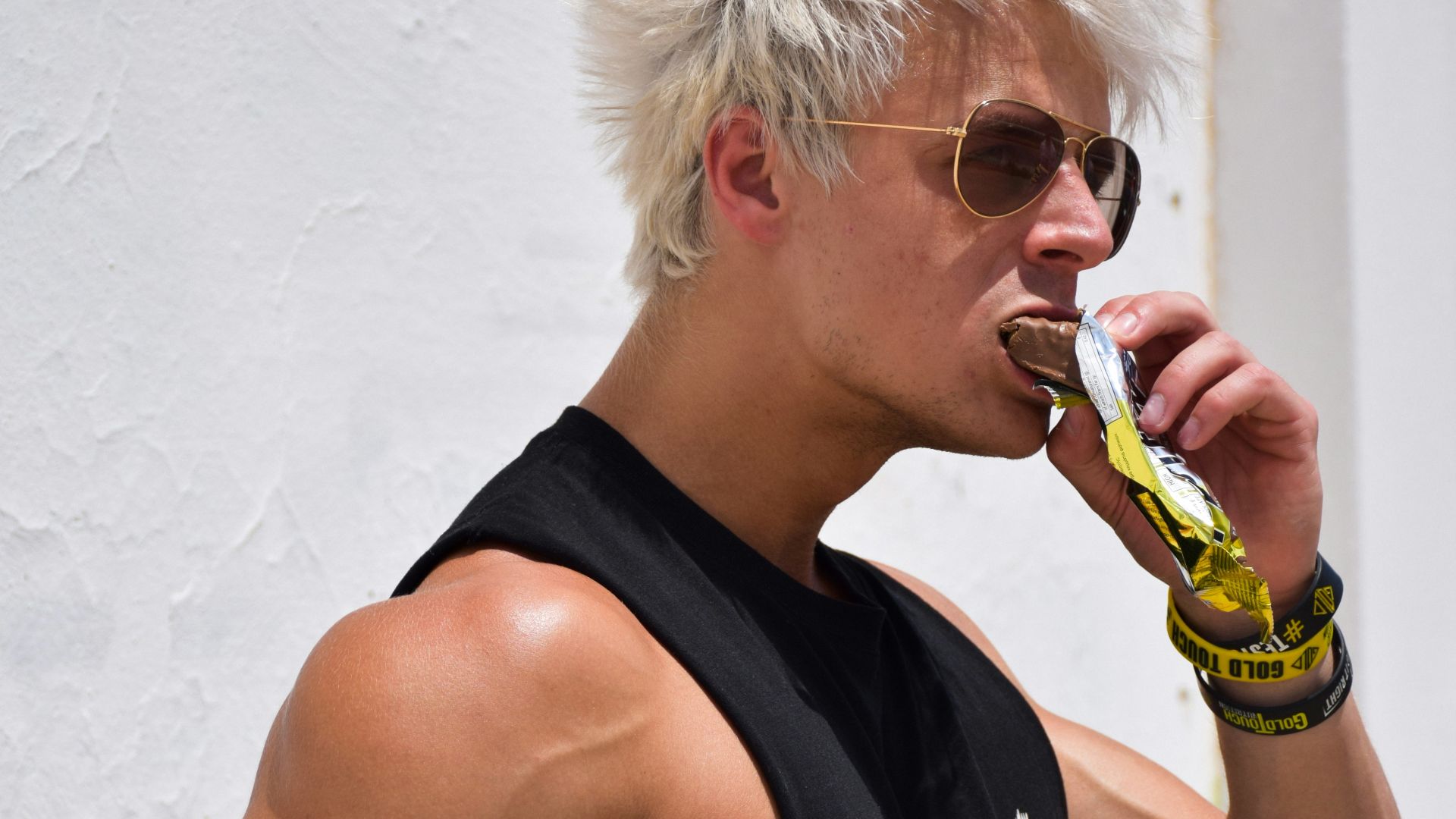 a man with white hair is drinking a drink