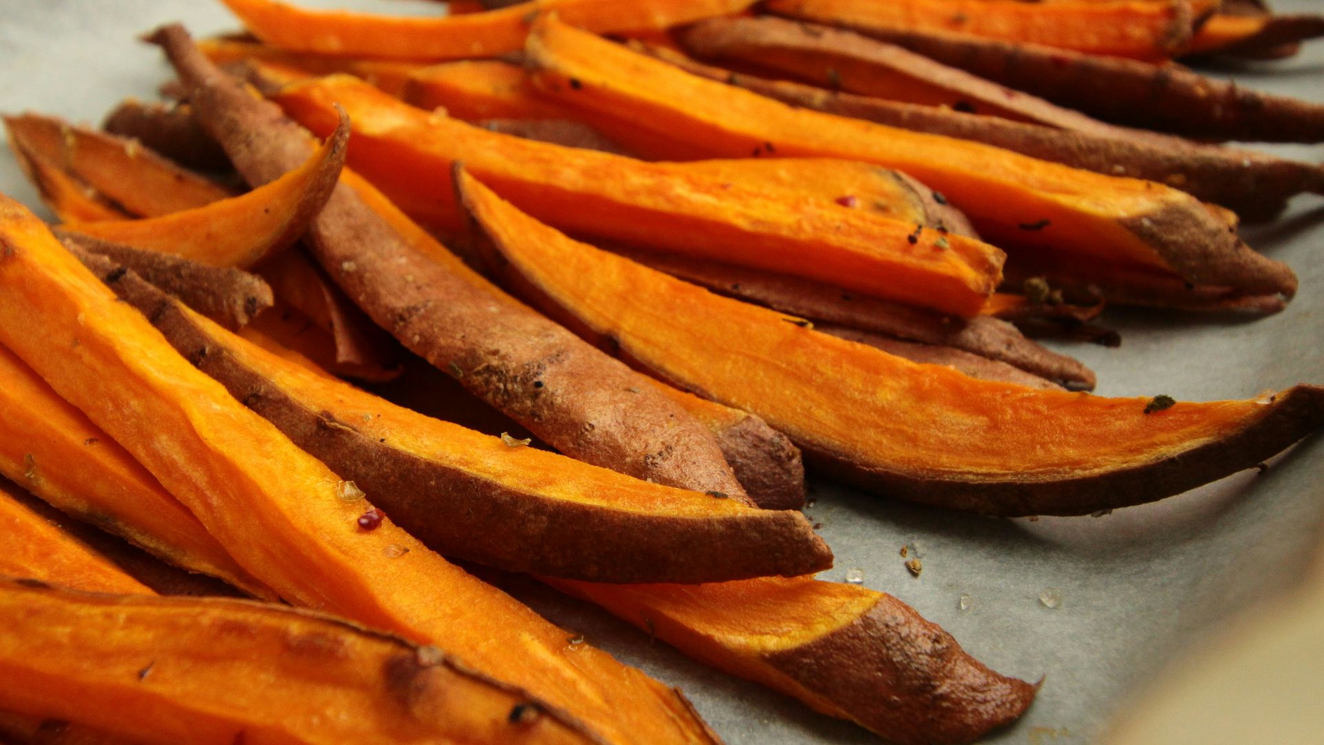 sliced orange fruit on white table