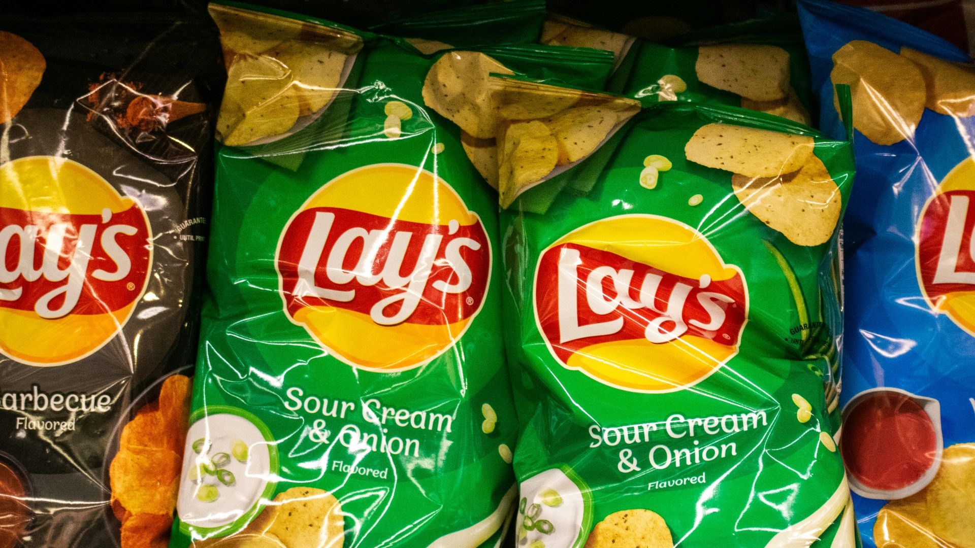 Several bags of lay's potato chips are displayed.