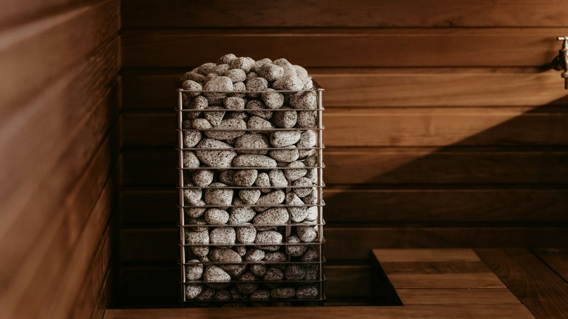 a basket filled with rocks sitting on top of a wooden table