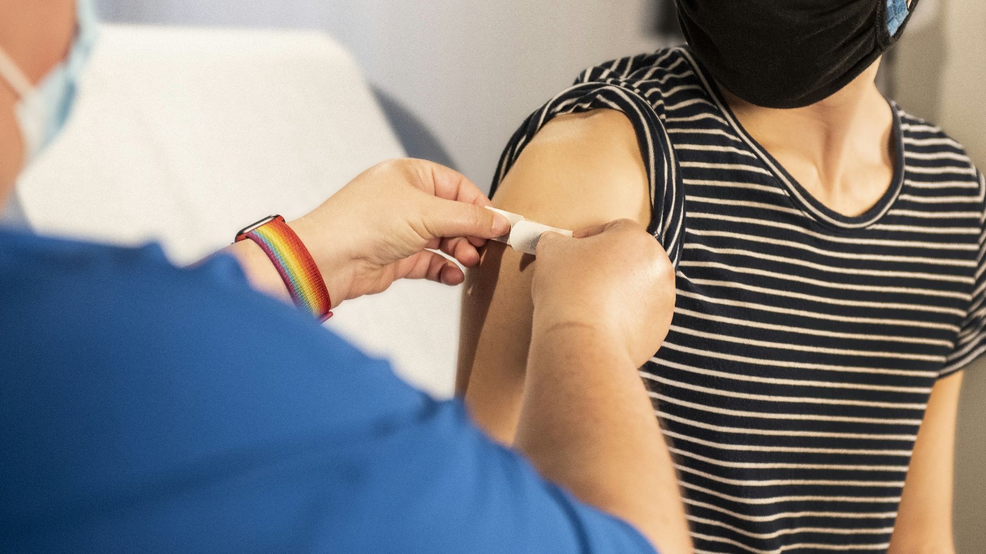 person in blue long sleeve shirt holding white textile