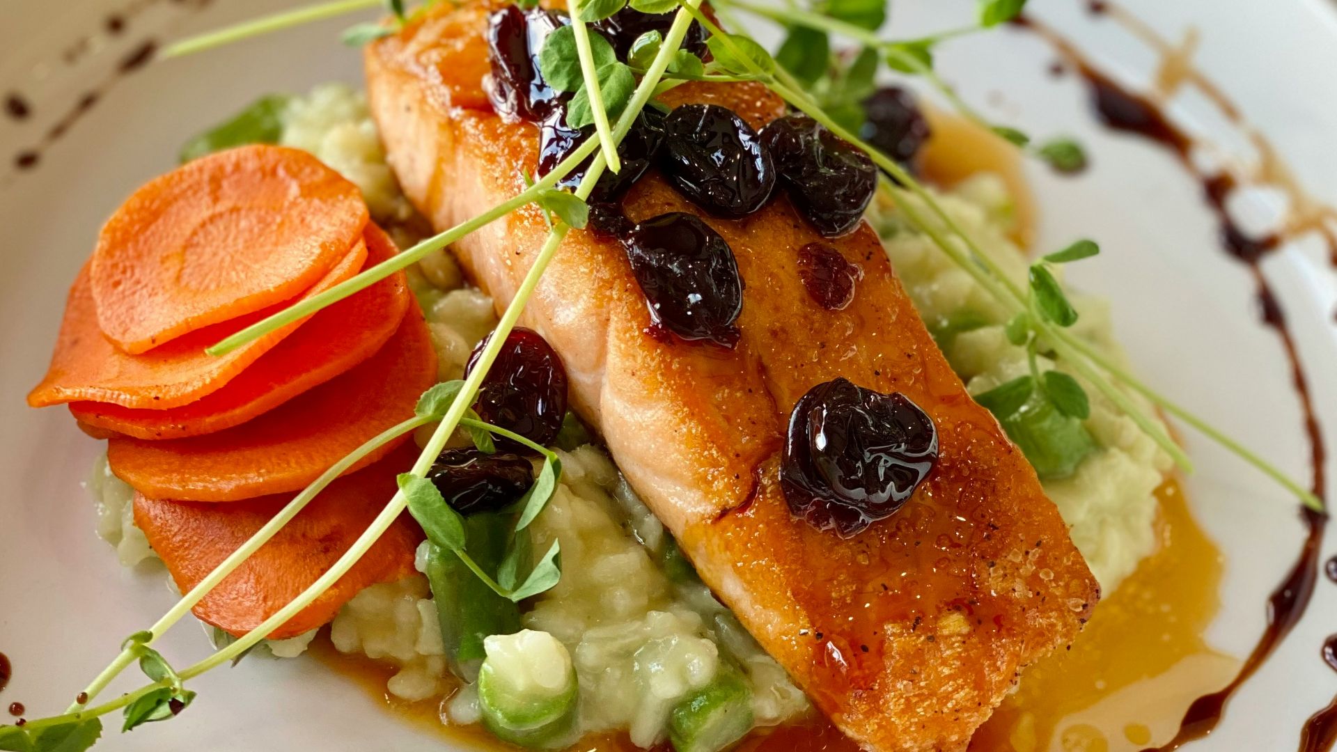 a white plate topped with fish and veggies