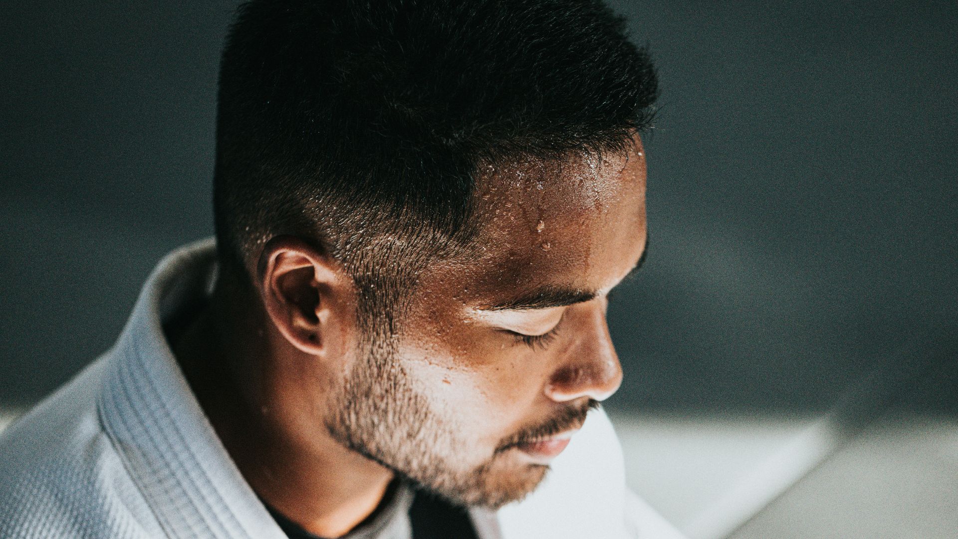 man in white shirt sitting on black chair