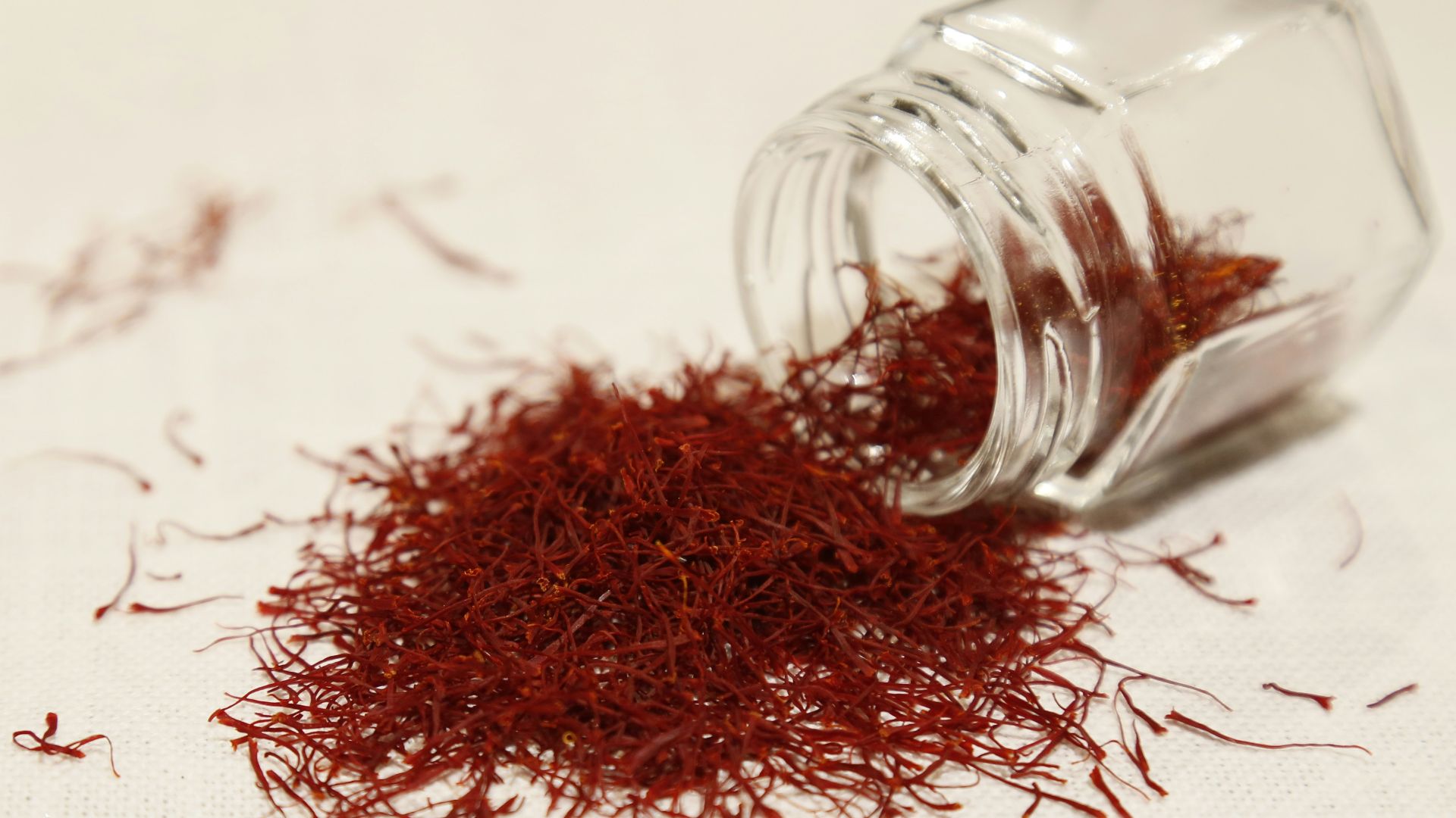 a glass jar filled with red stuff on top of a table