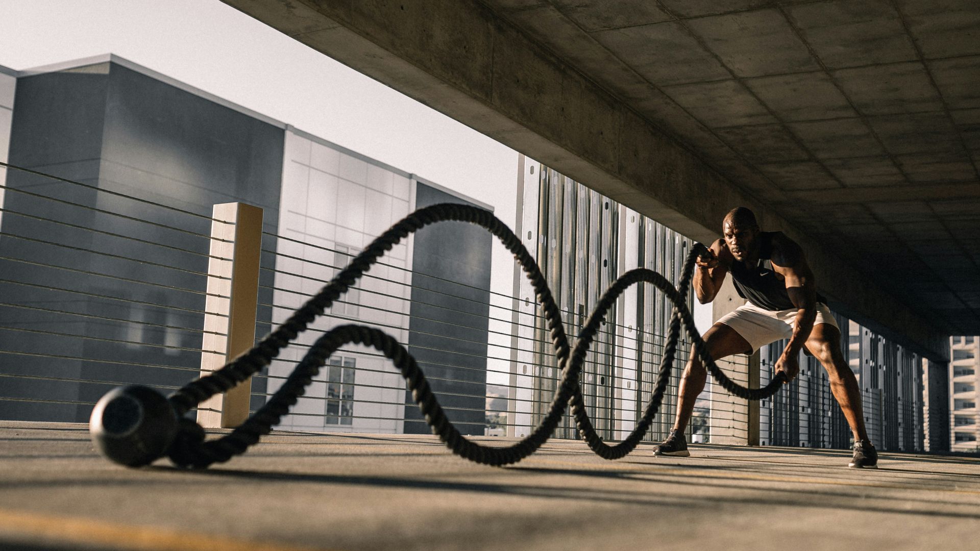 woman in black tank top sitting on brown wooden bench