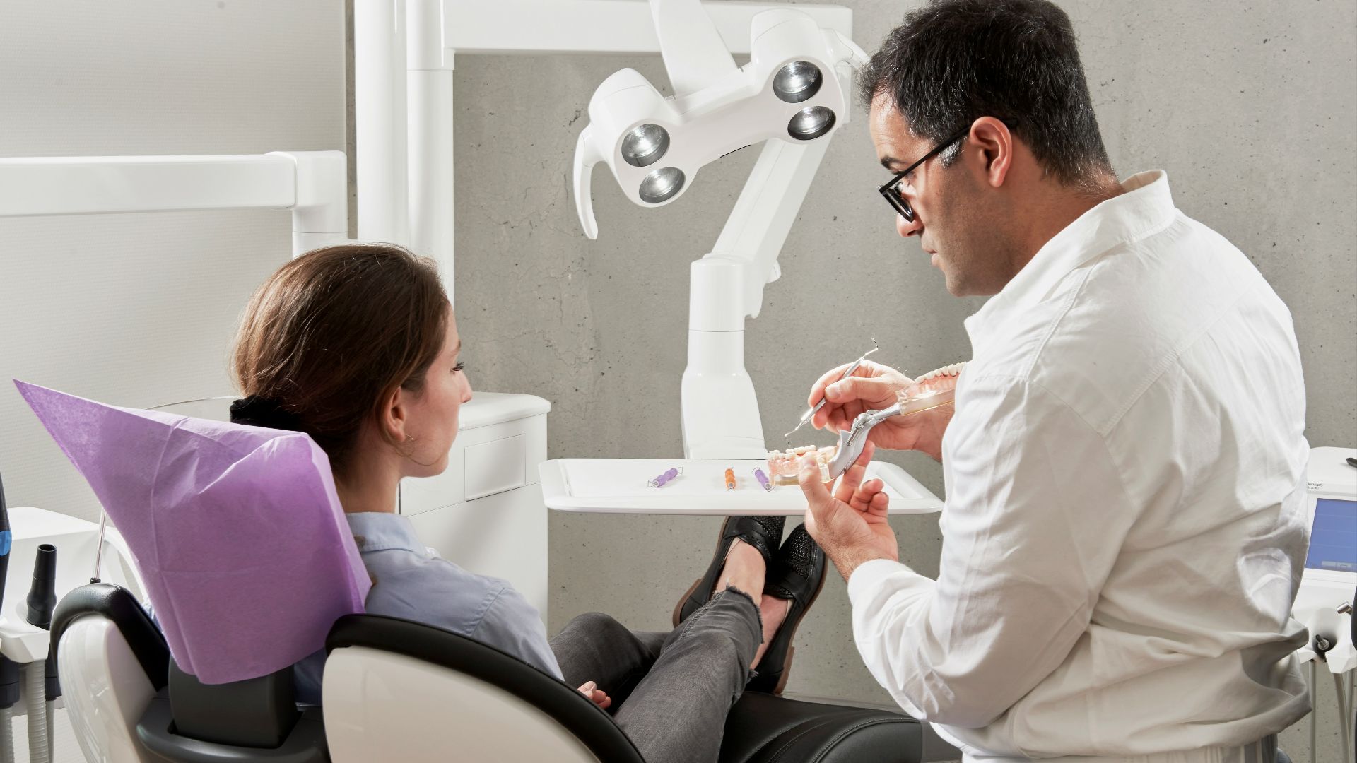 man in white dress shirt sitting on black office rolling chair