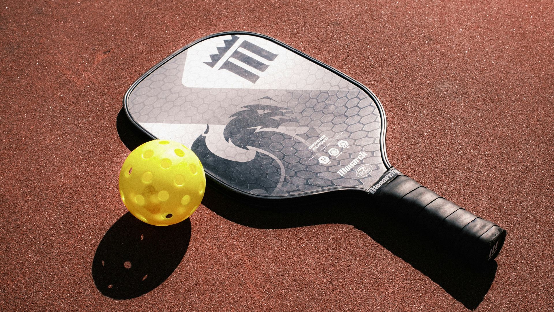 a tennis racket and ball on a court