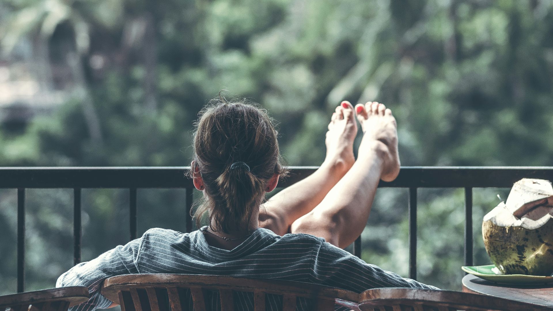 person sitting on chair in front of tree