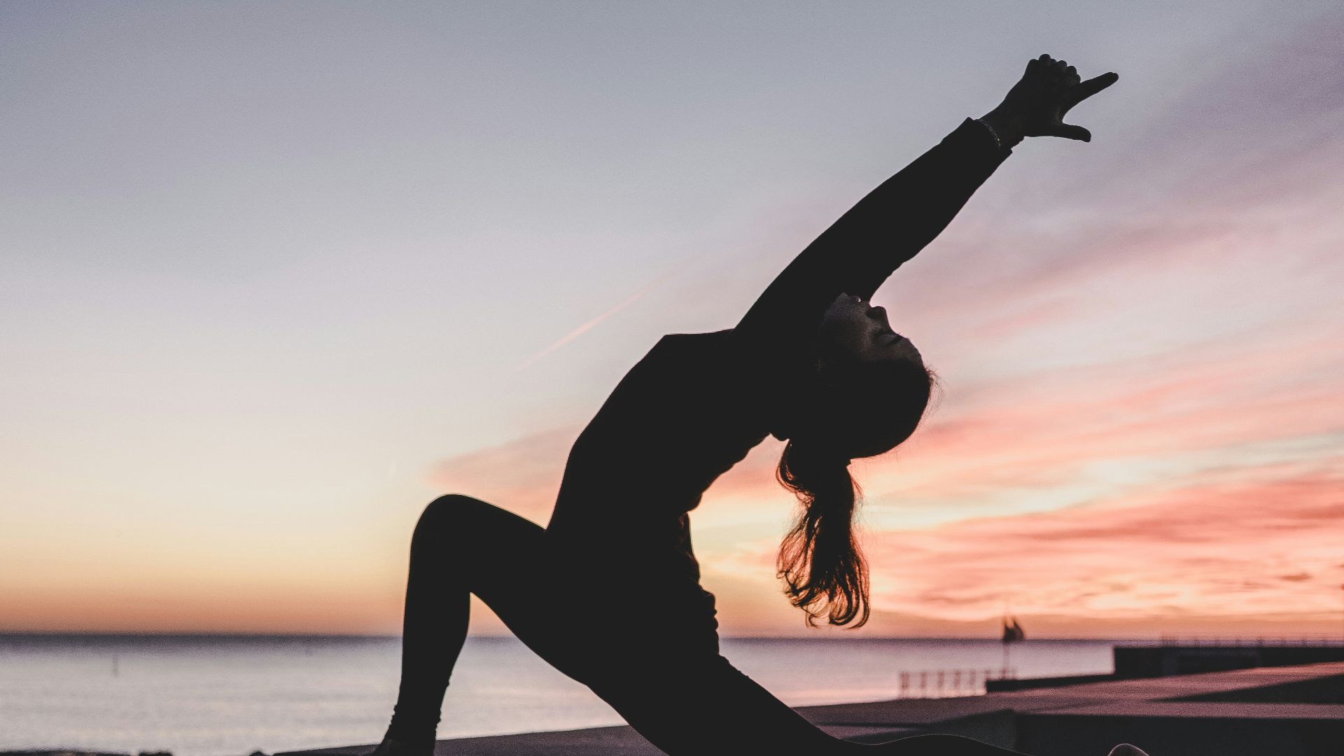 silhouette photography of woman doing yoga