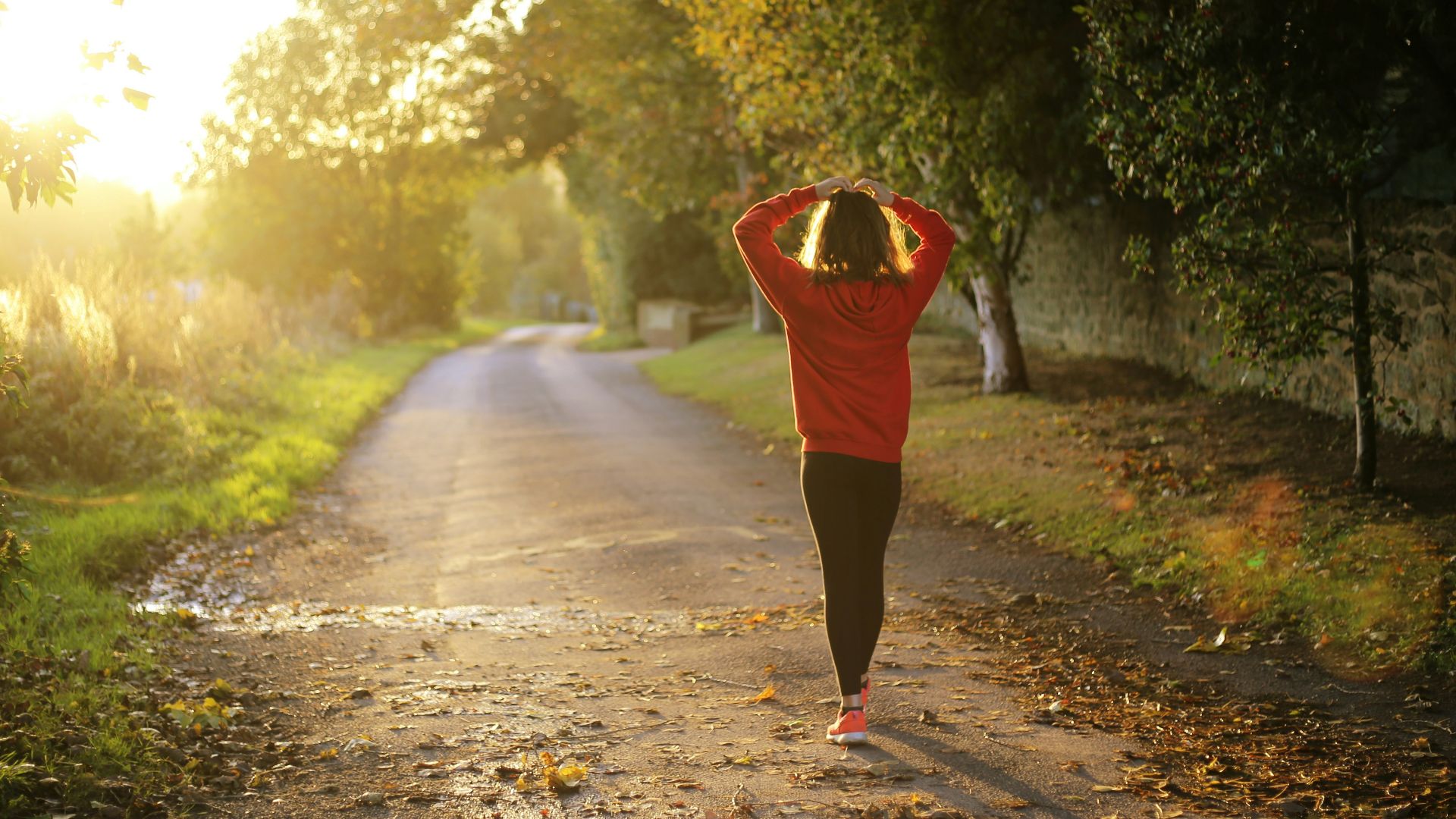 woman walking on pathway during daytime