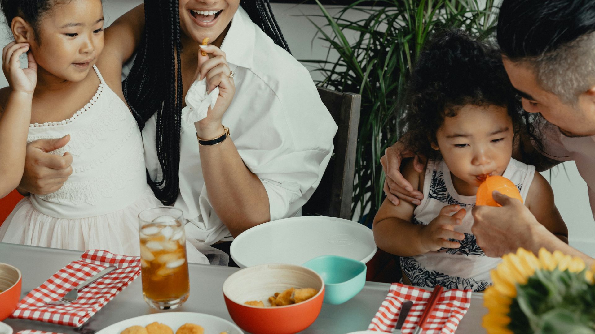 woman in white sleeveless dress sitting beside woman in white sleeveless dress