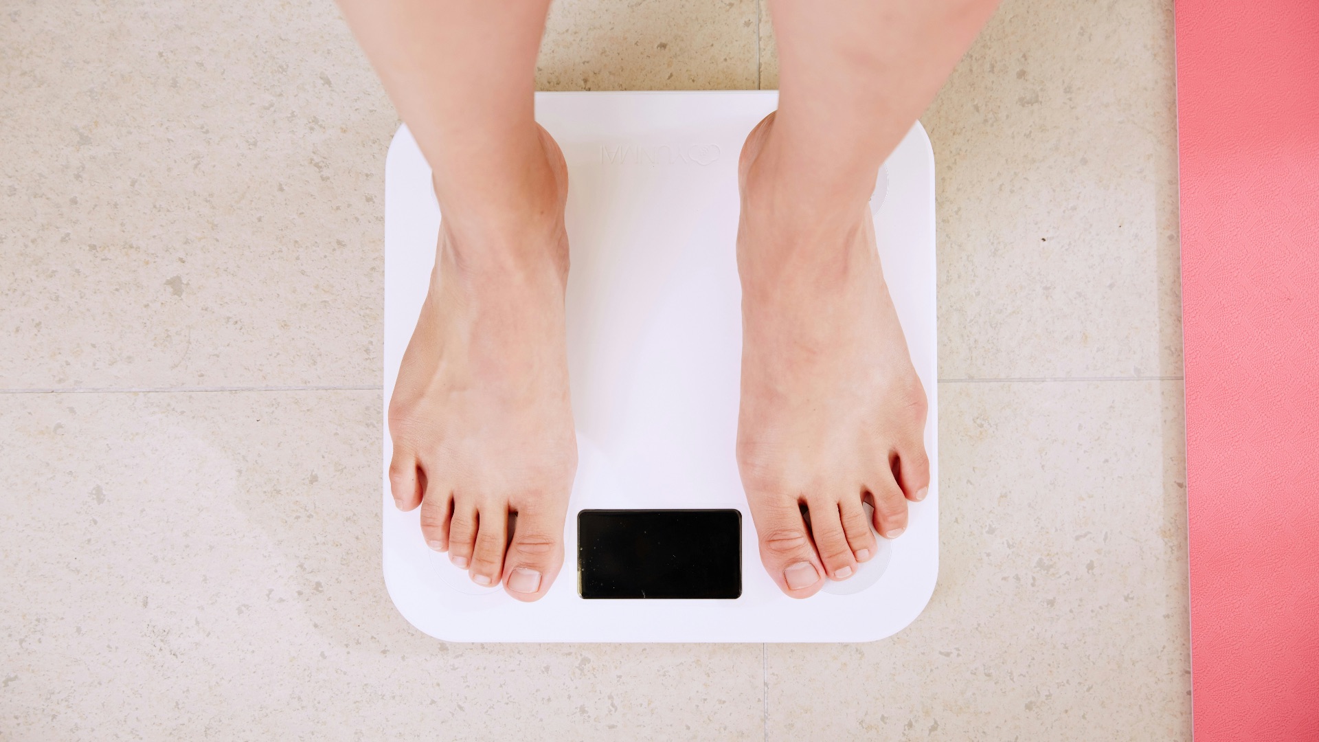 person standing on white digital bathroom scale