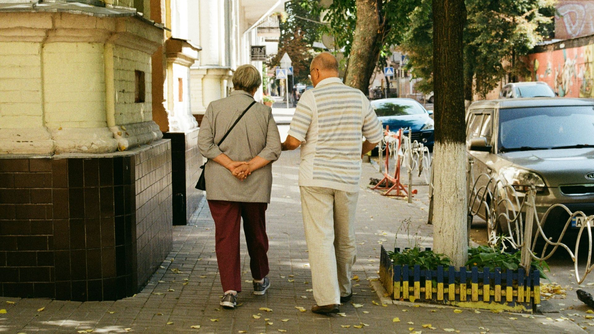 man in white dress shirt and red pants standing near man in white dress shirt