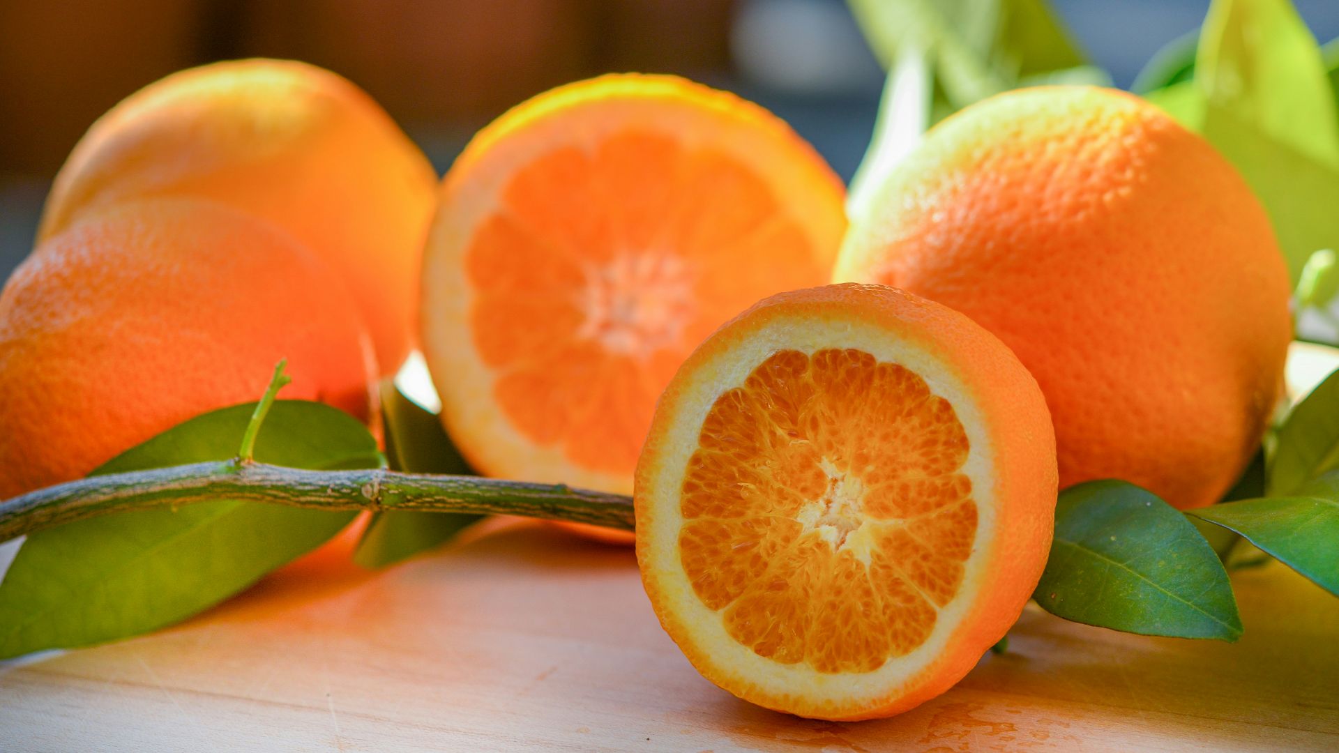 a group of oranges sitting on top of a wooden table