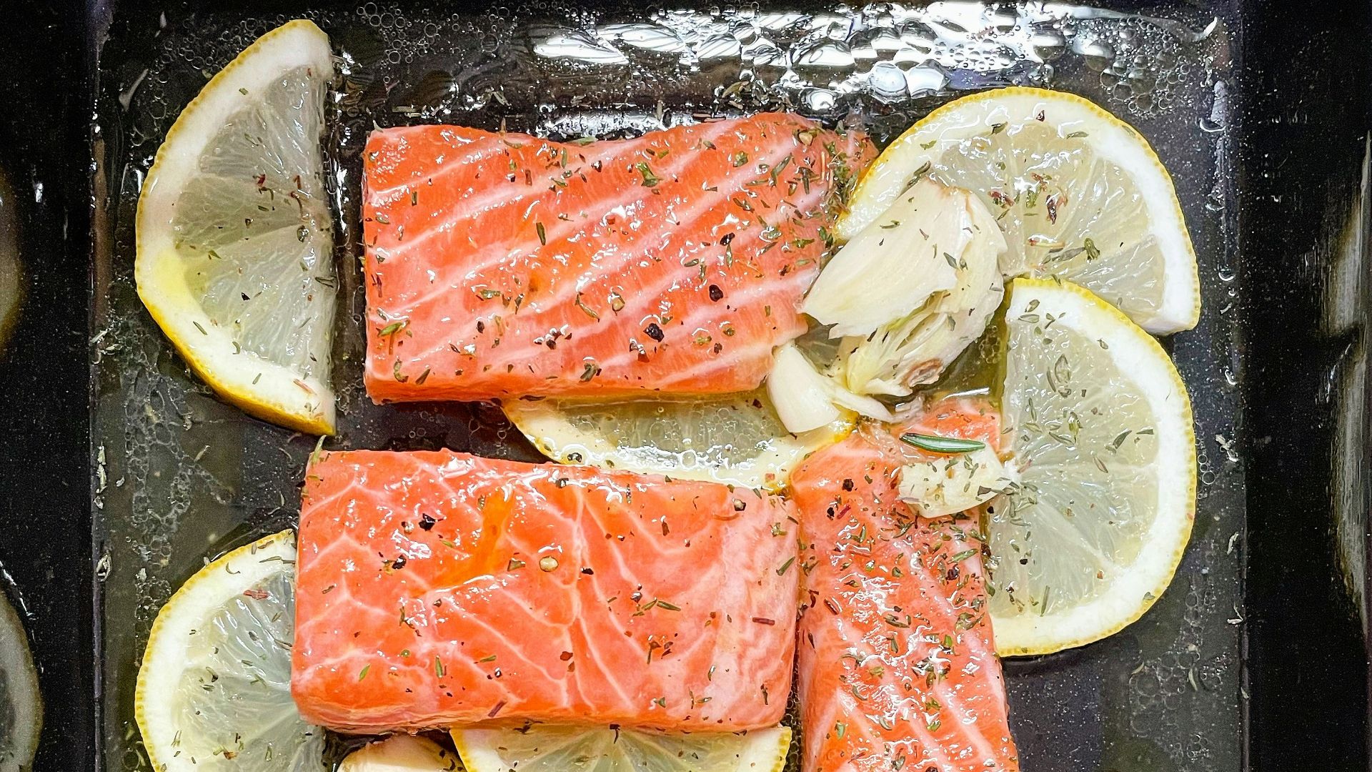 sliced fish meat on black plate