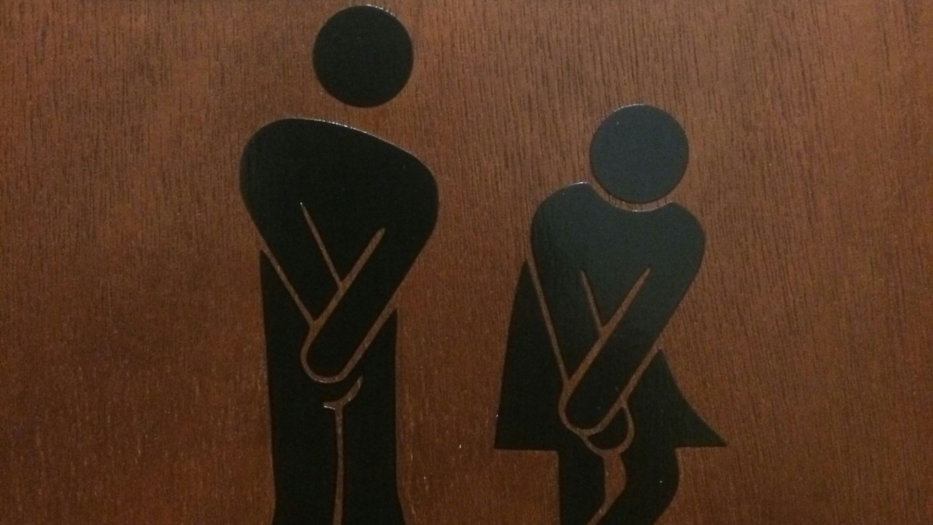 a toilet sign with a picture of a man and a woman