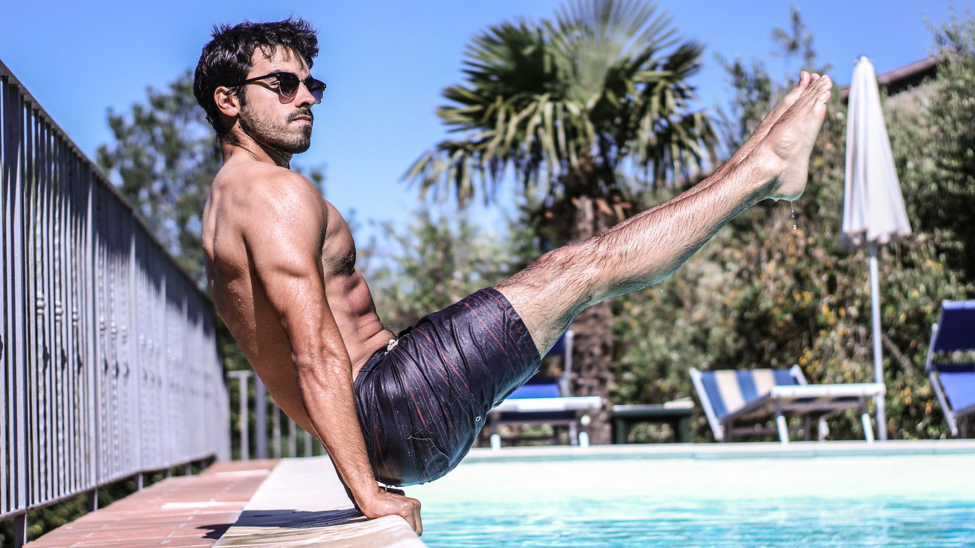 man sitting beside pool