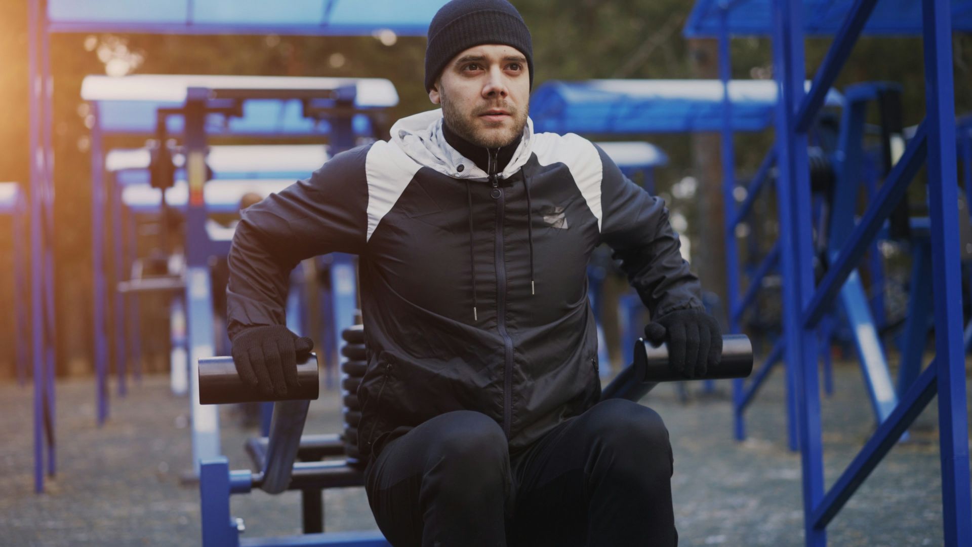 Man exercising on outdoor gym equipment