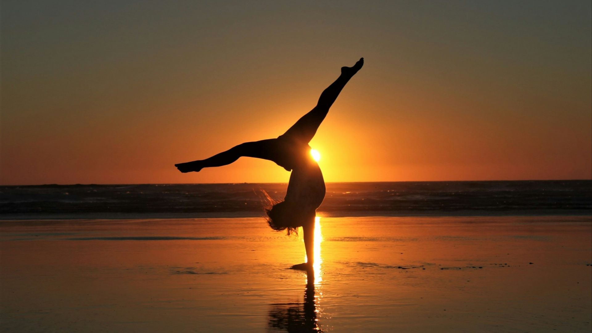 woman in white dress standing on beach during sunset