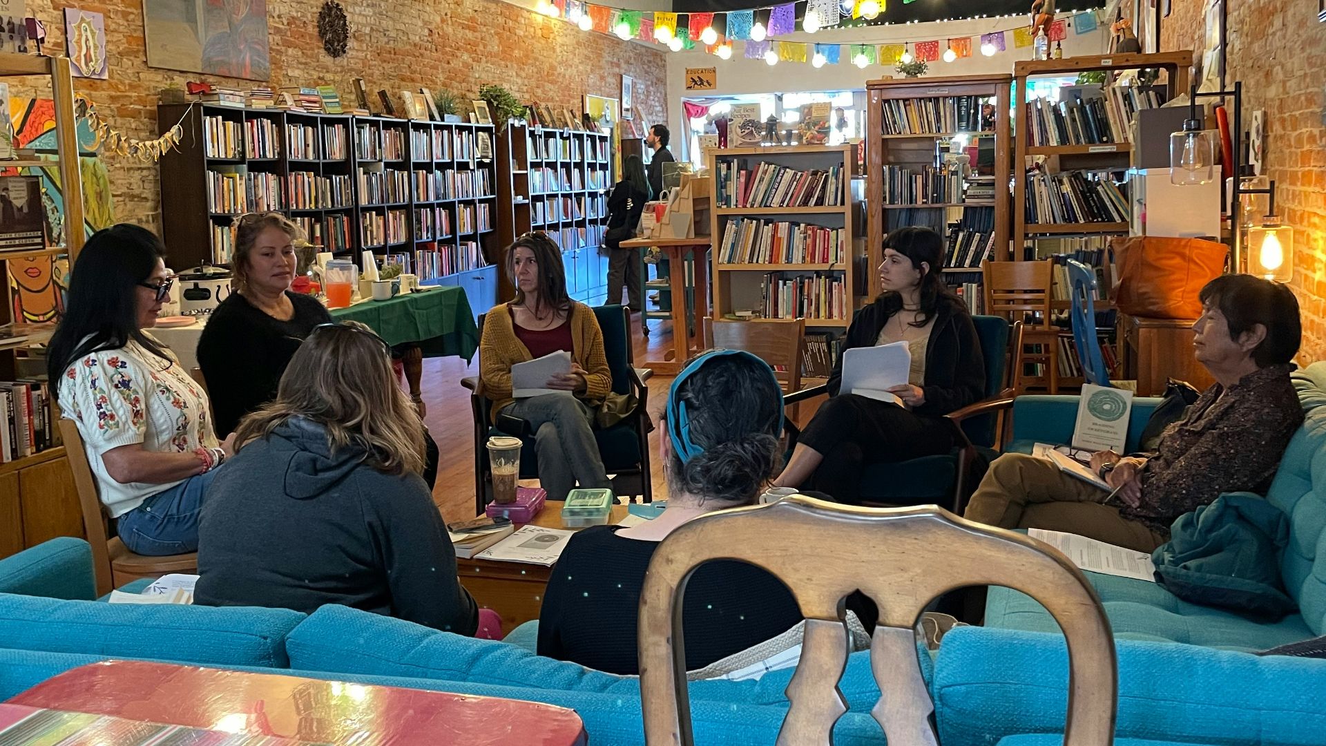 A group of people sitting at tables in a library