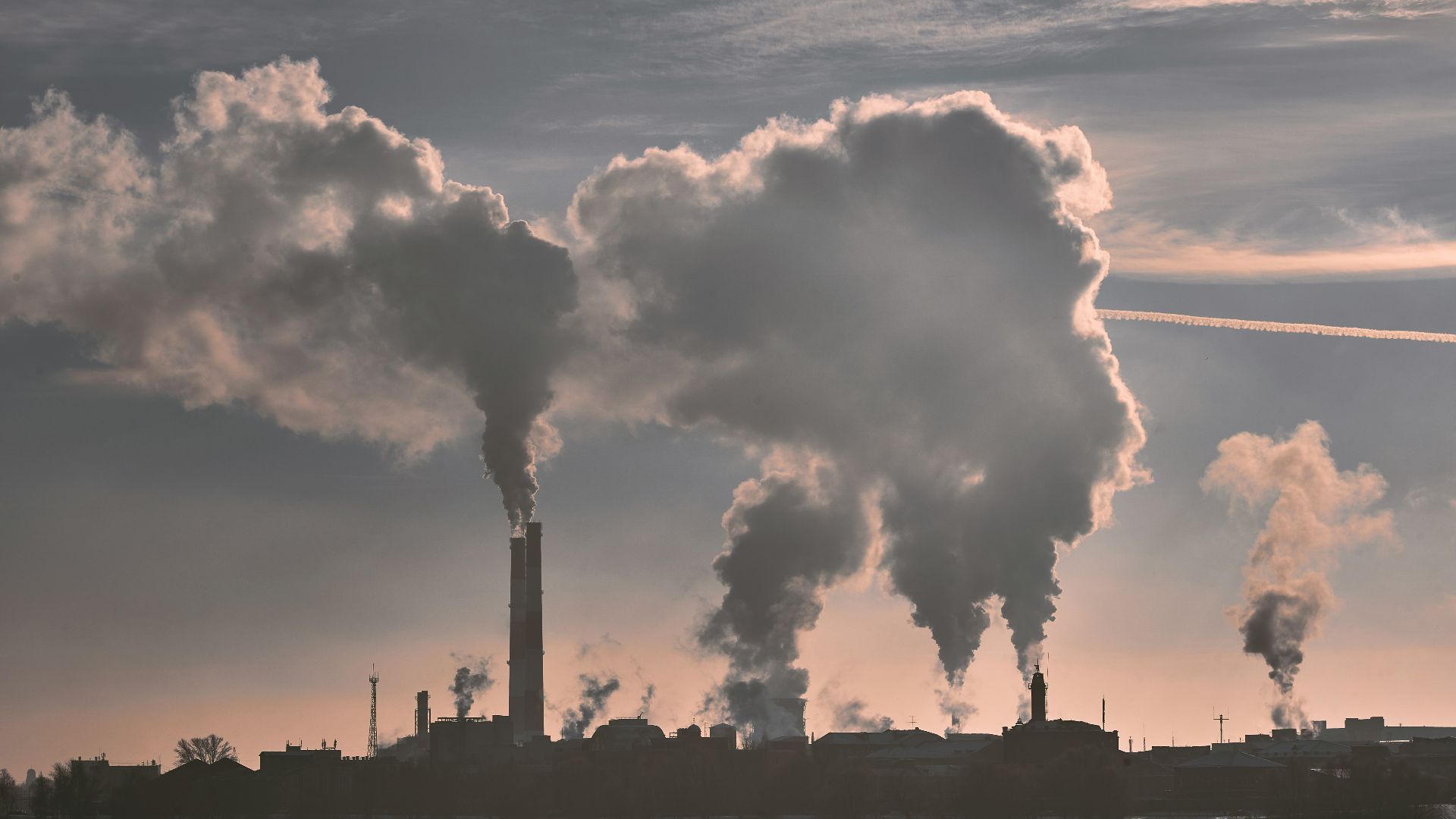 silhouette of building under white clouds during daytime
