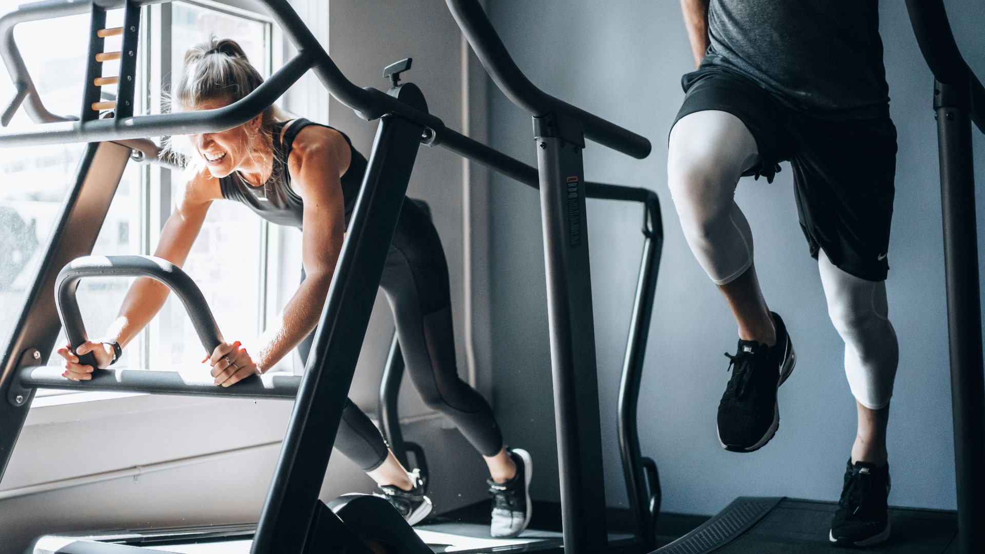 woman in black tank top and black shorts sitting on black exercise equipment