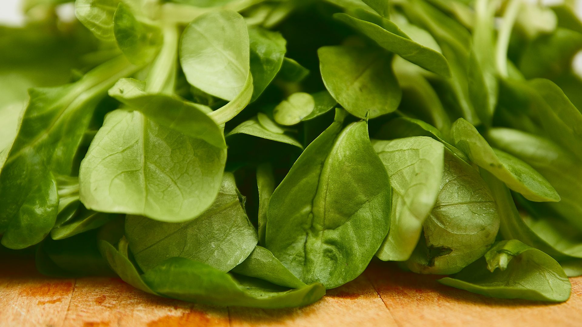 green leaves on brown wooden table