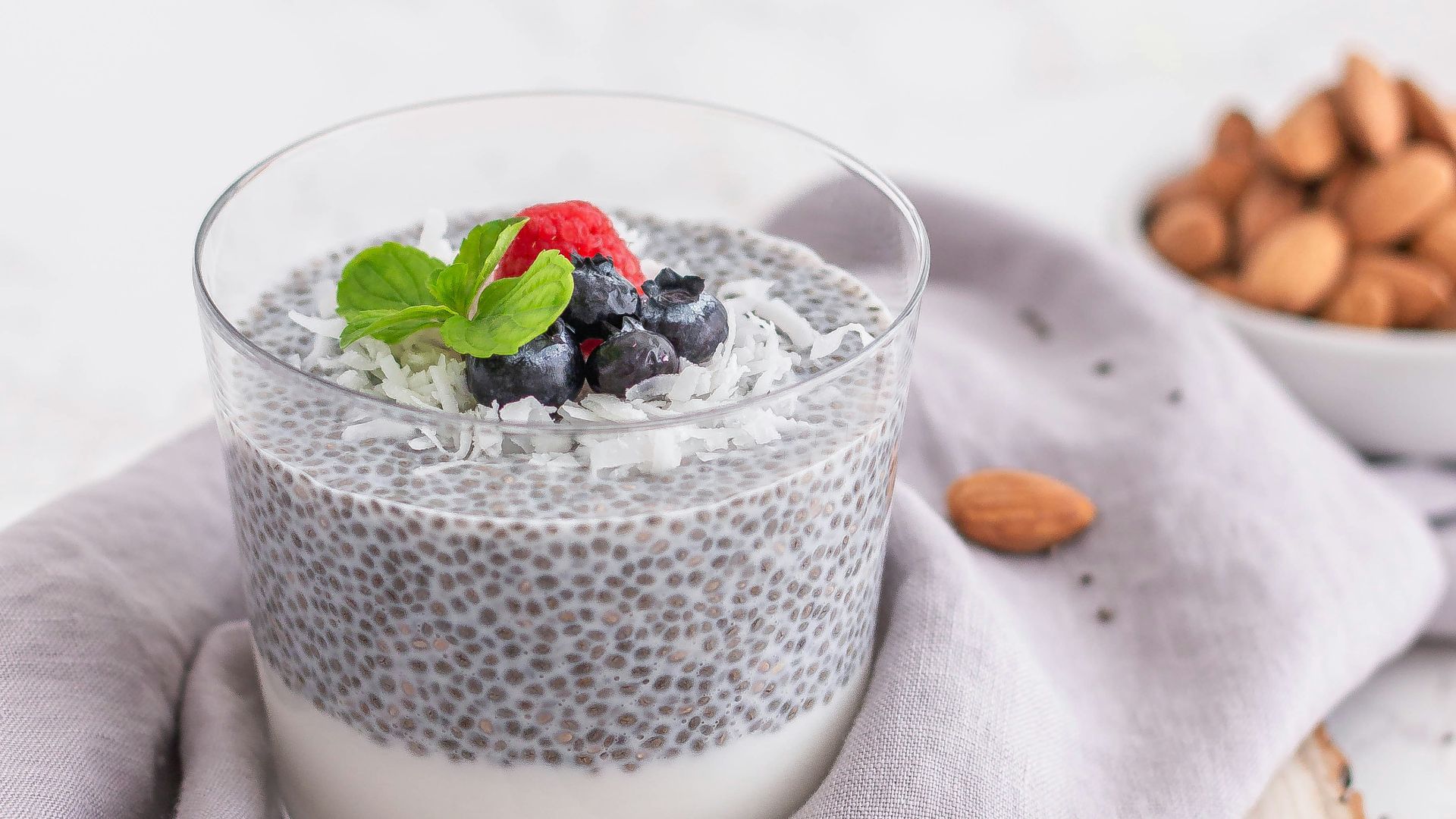 a glass of milk with berries and a spoon