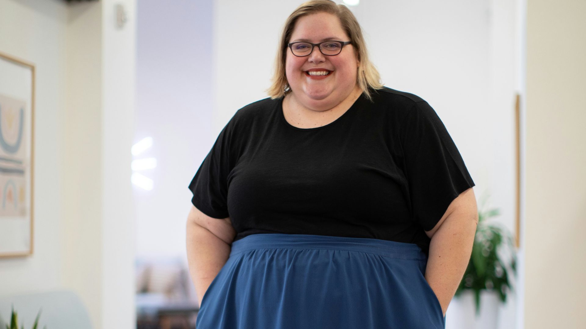 photography of smiling woman standing inside room