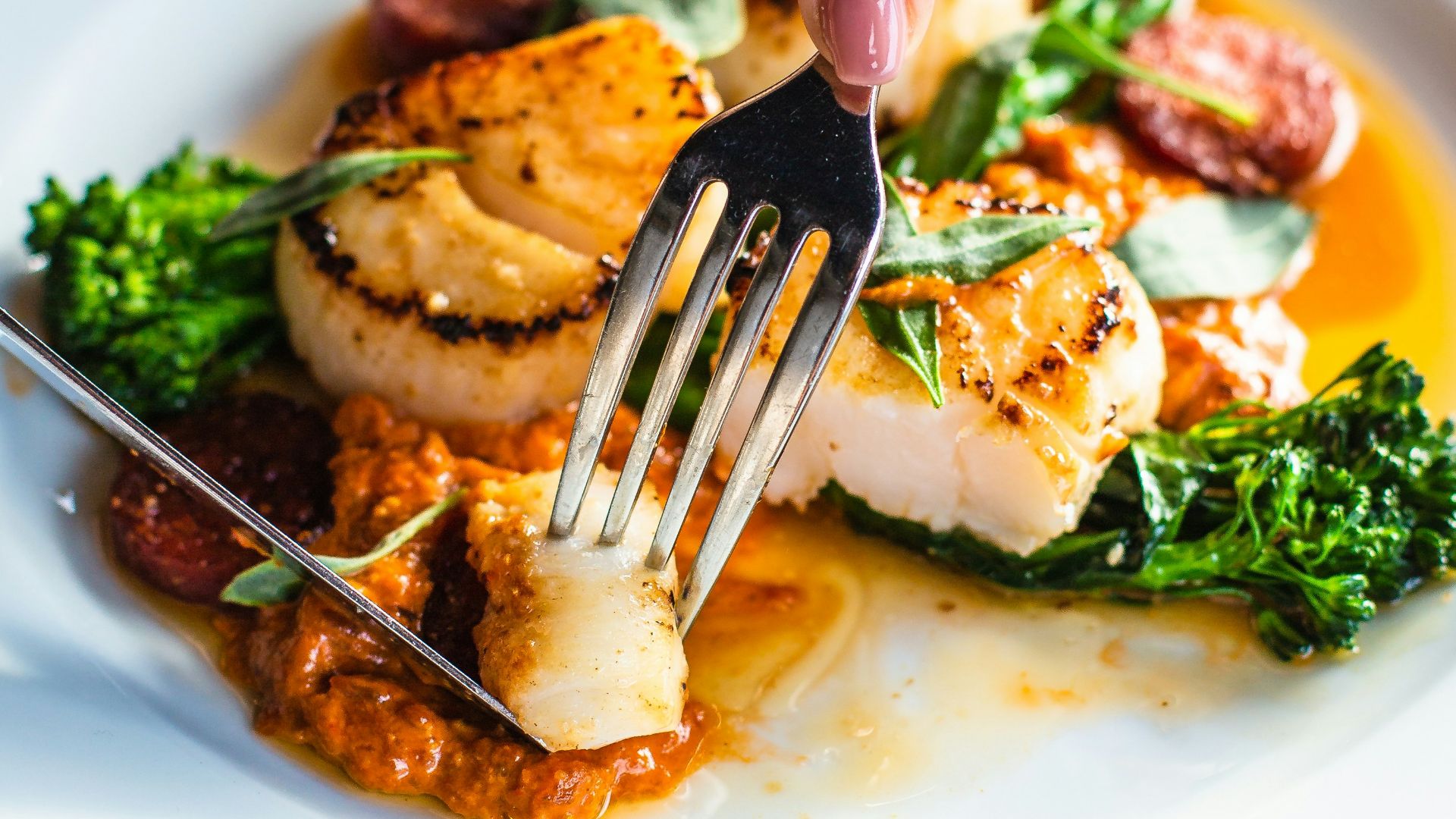 stainless steel fork on white ceramic plate