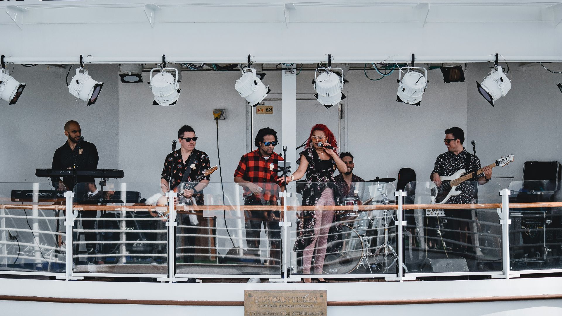 people on terrace with stage lamps