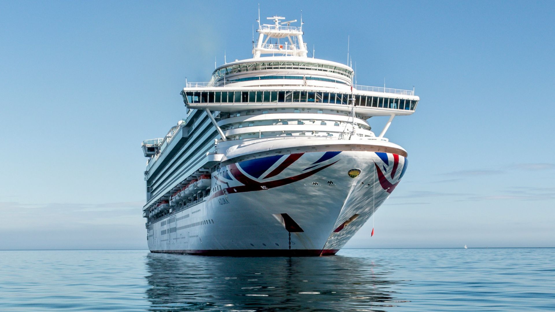 white and blue boat on sea under blue sky during daytime