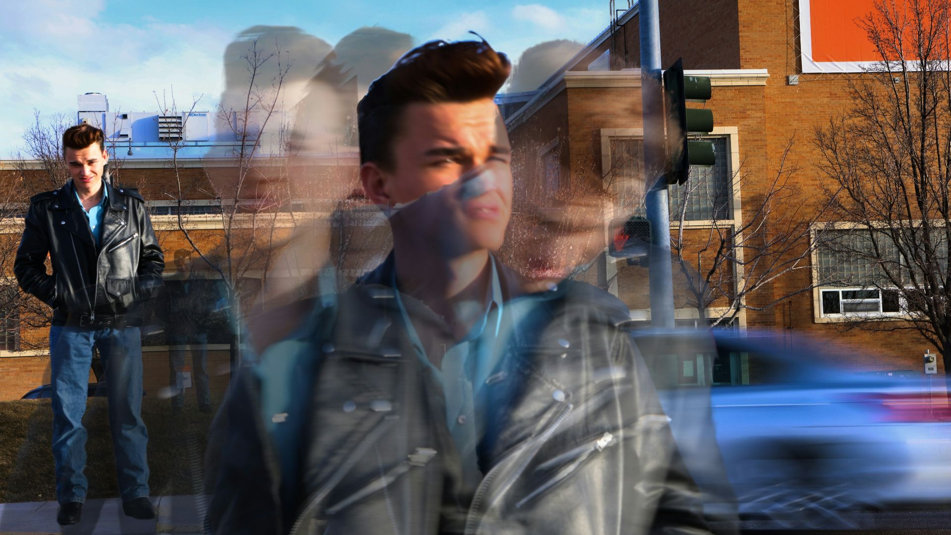 Blurred image of a man walking down the street.