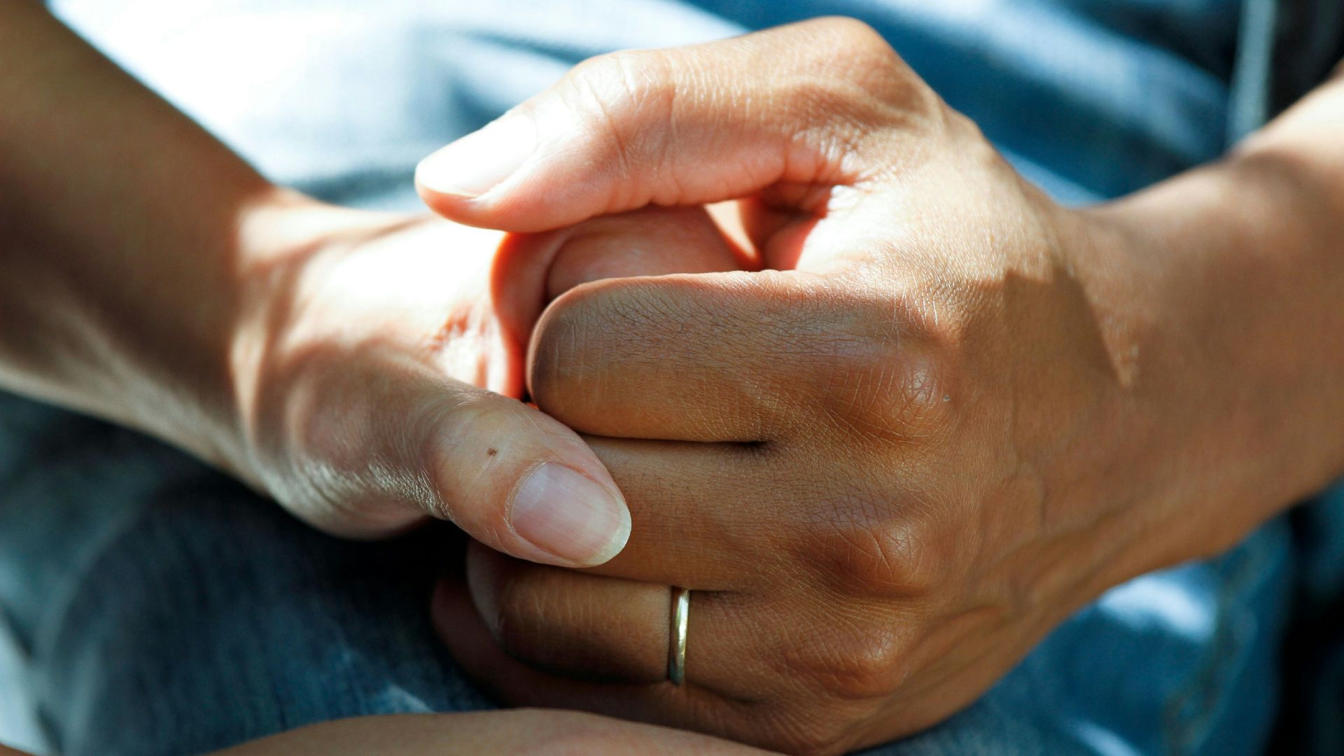 person wearing gold wedding band