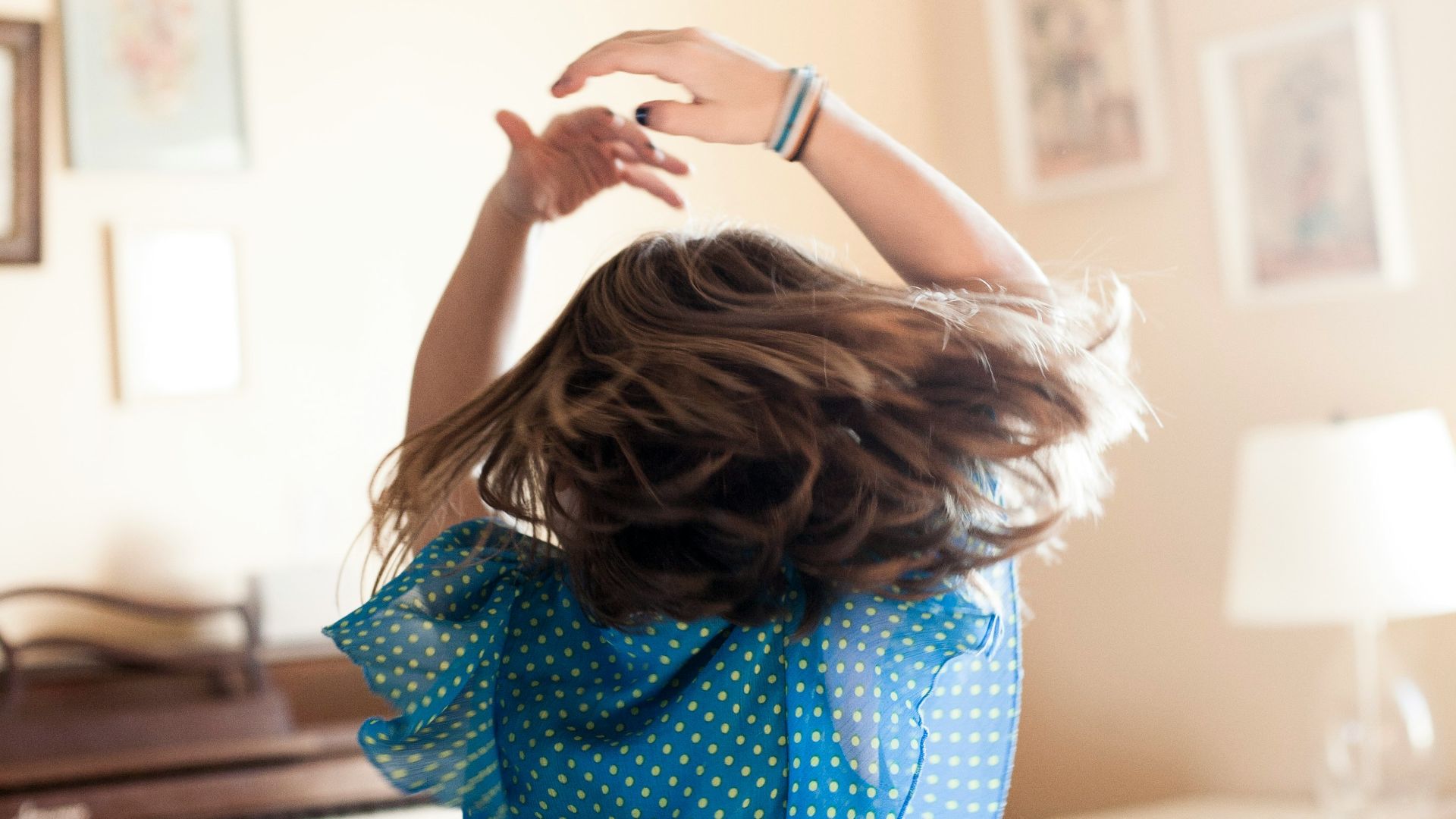 girl twirling around room