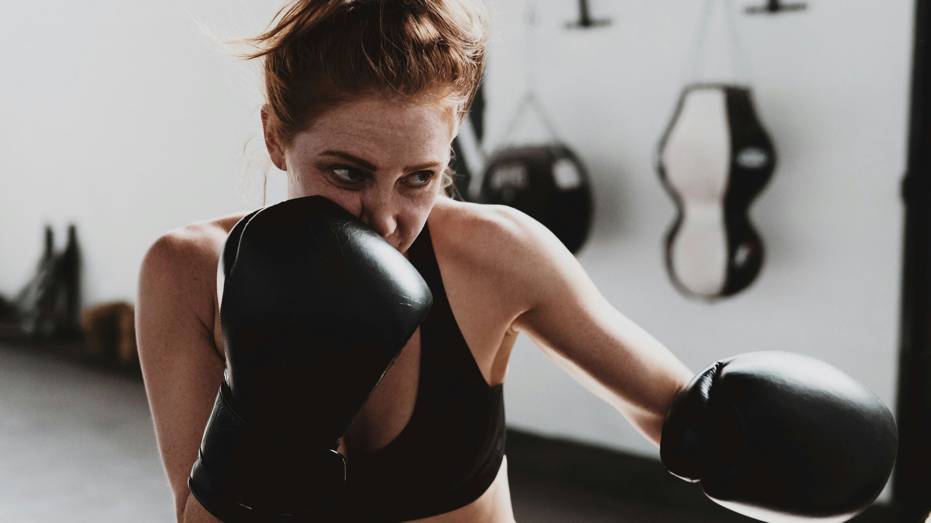 woman in black sports bra and black leggings doing exercise