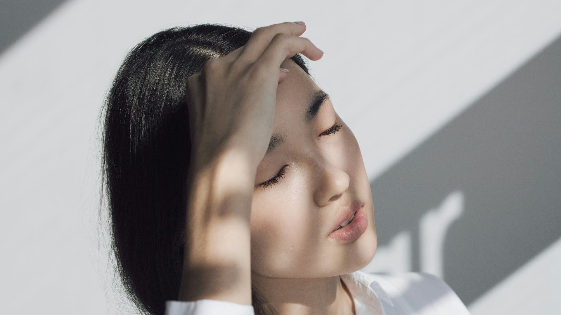 woman leaning on white table