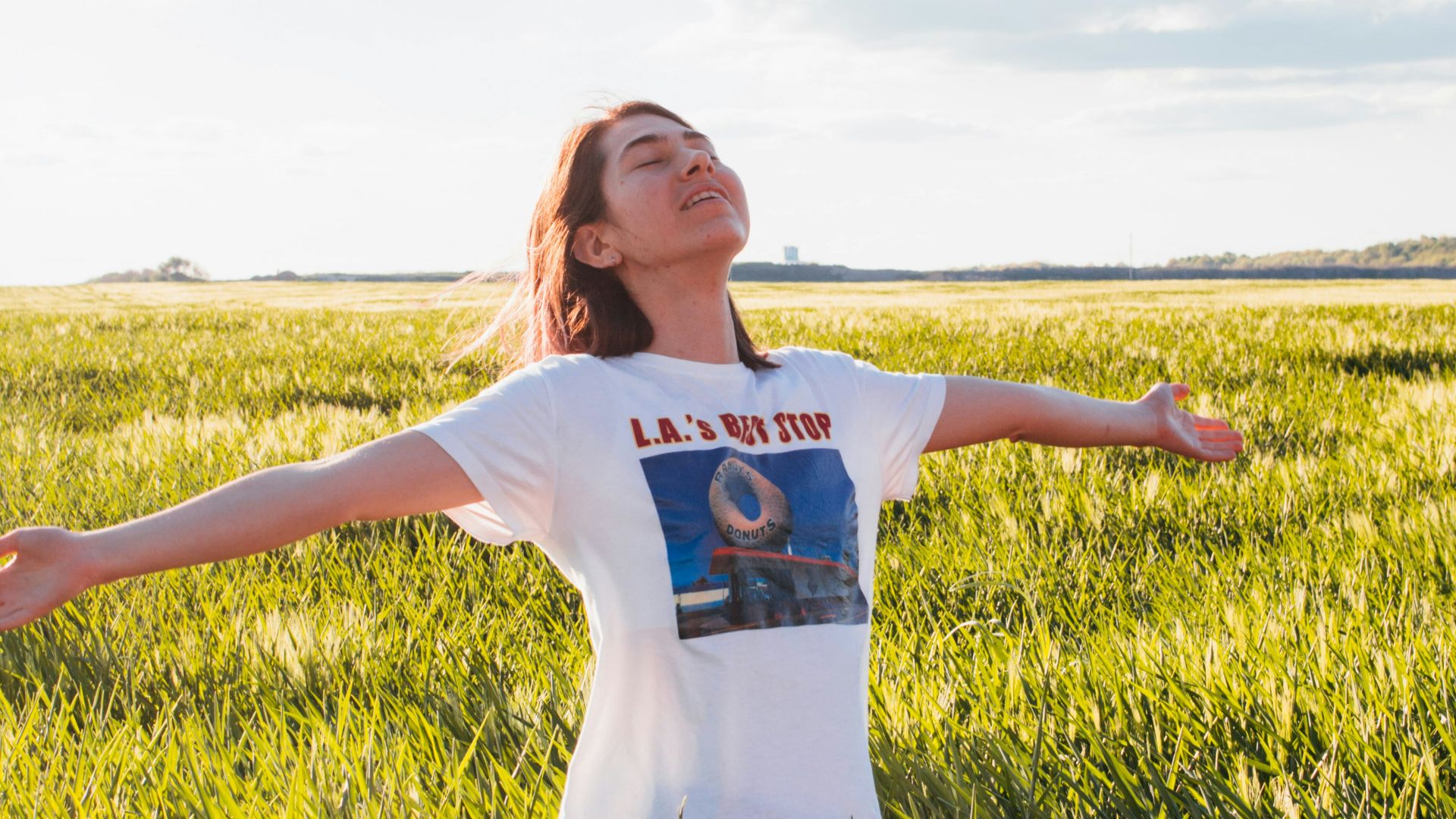 woman standing in green field