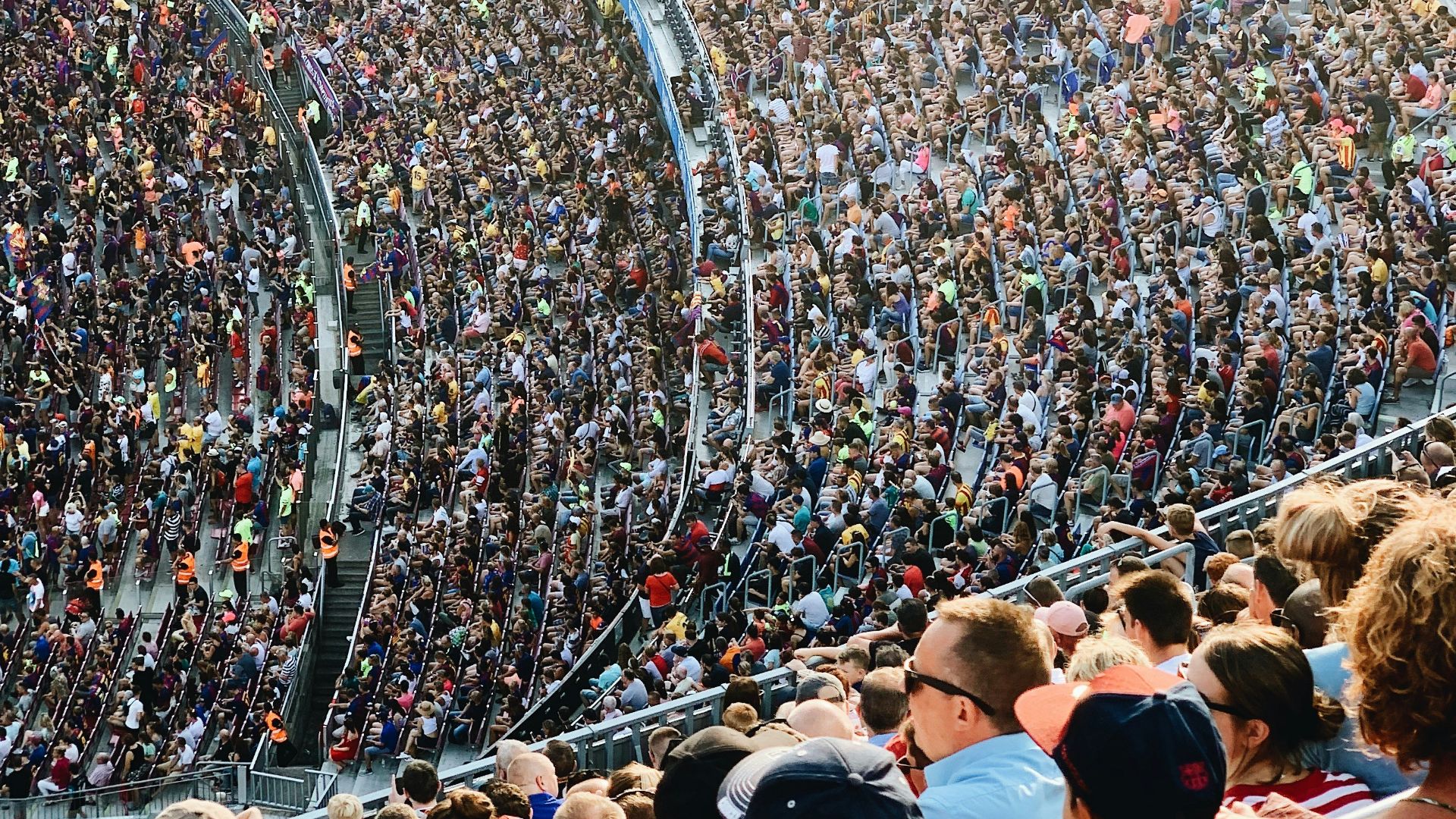 people sitting inside stadium seats
