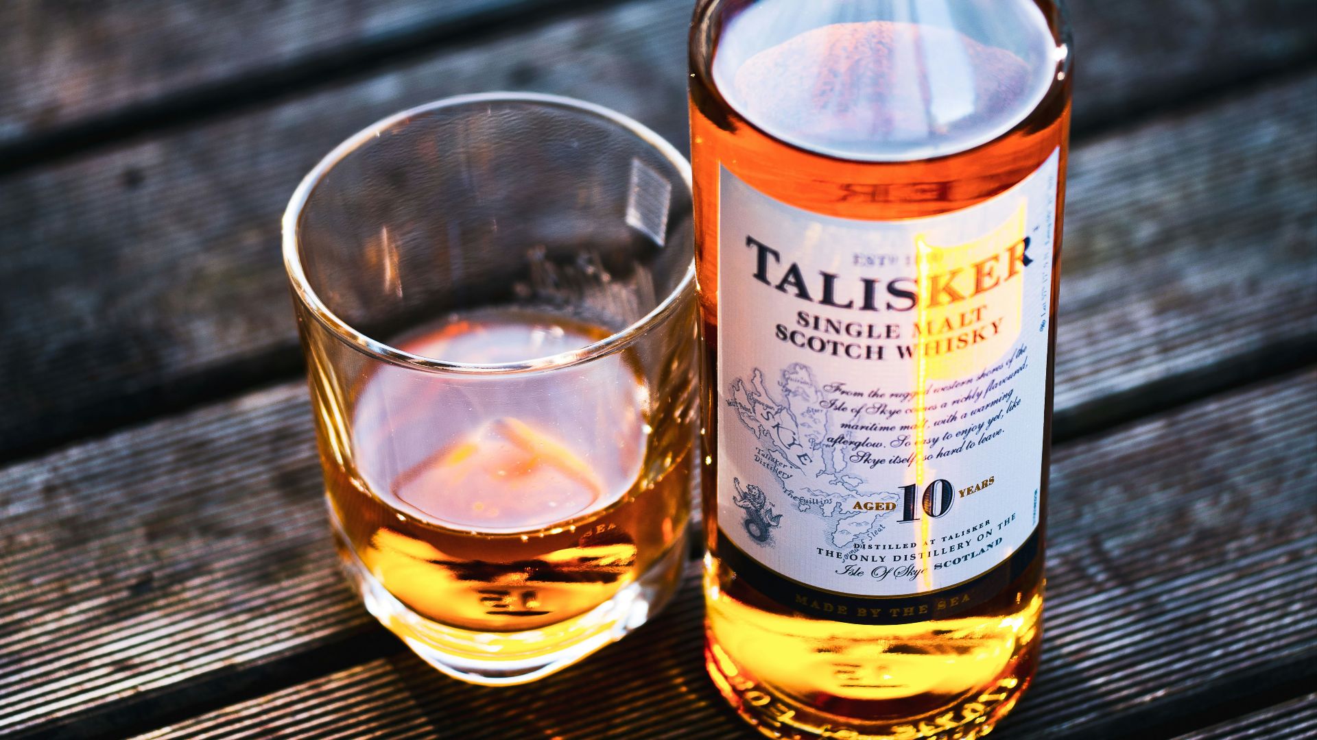 Talisker bottle beside drinking glass