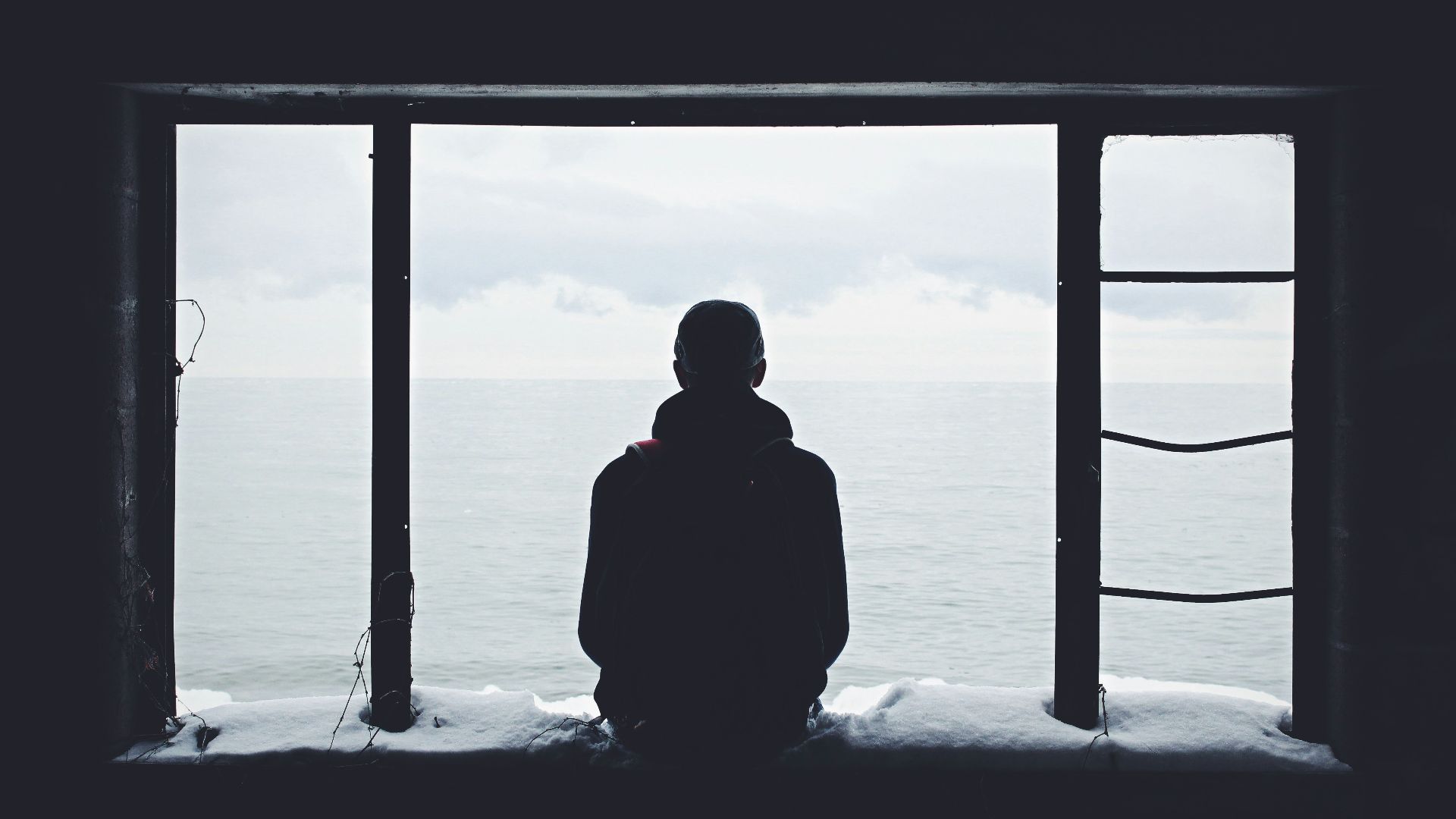 person looking out through window