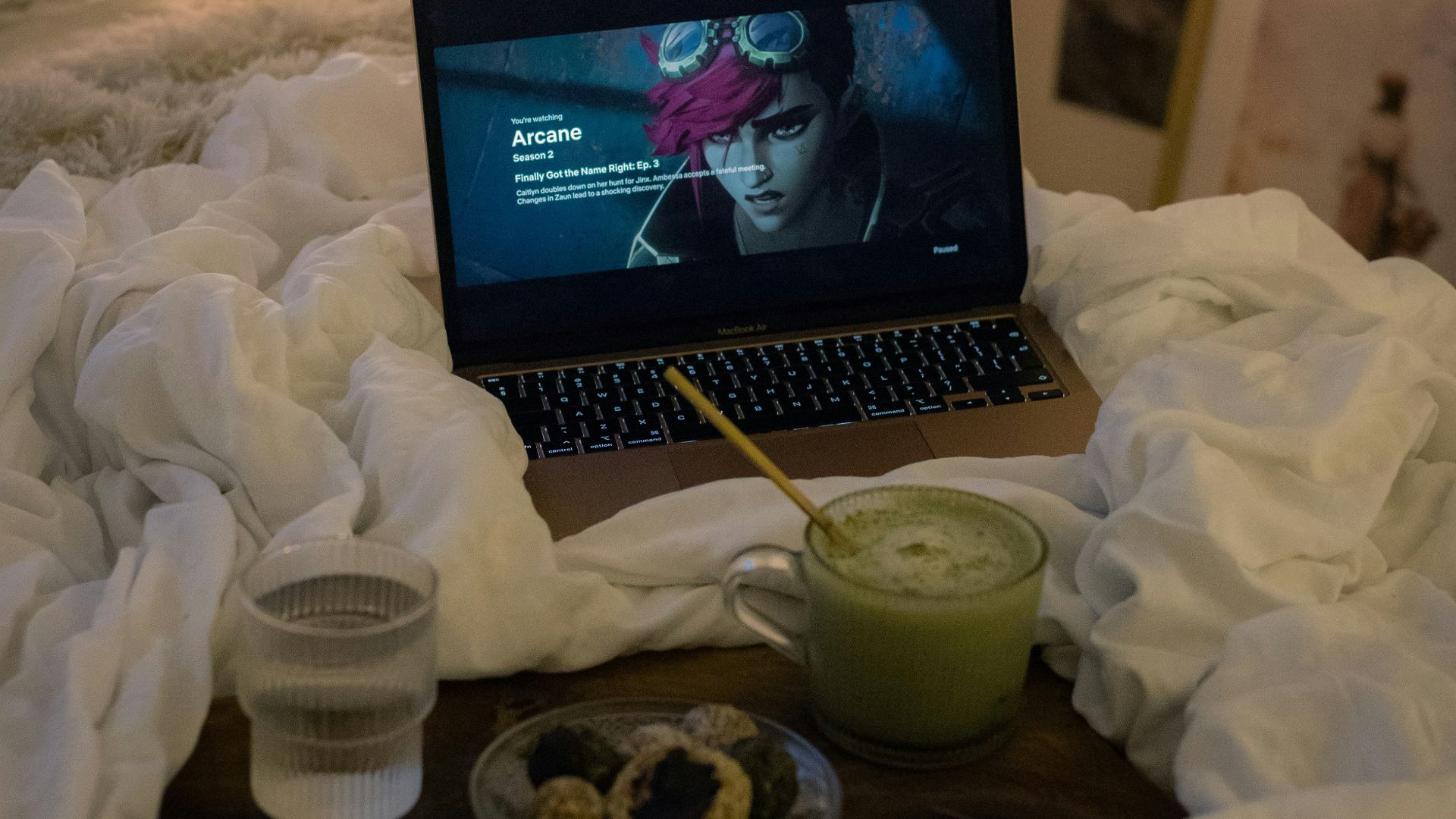 A laptop computer sitting on top of a bed